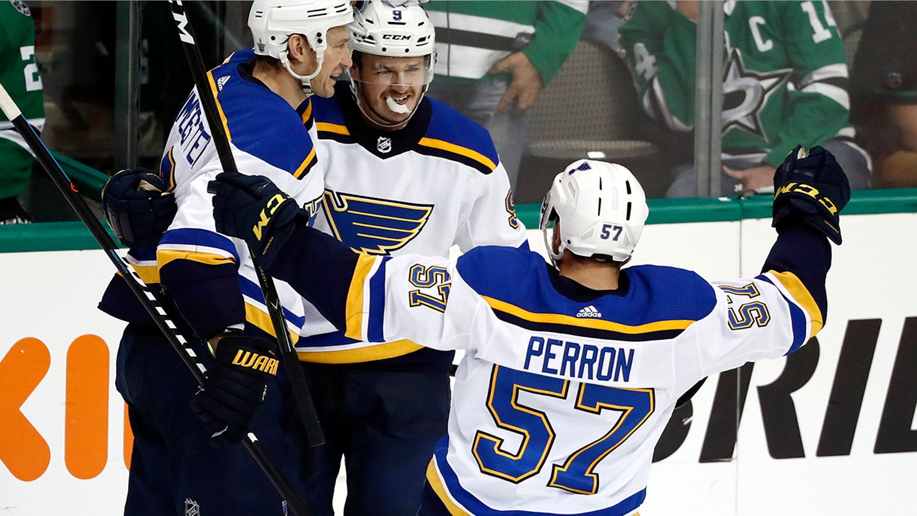 St. Louis Blues' Sammy Blais is congratulated by teammates Jay Bouwmeester, left, and David Perron (57) after scoring during the third period in Game 6 of an NHL second-round hockey playoff series against the Dallas Stars, Sunday, May 5, 2019, in Dallas. The Blues won 4-1. (AP Photo/Tony Gutierrez)