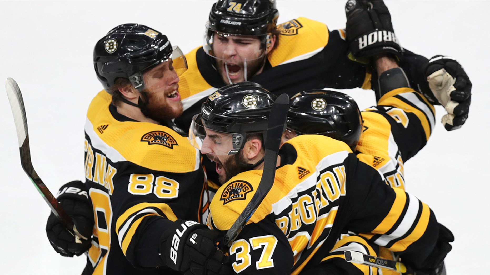 Boston Bruins' Patrice Bergeron (37) is congratulated by teammates after his goal against the Carolina Hurricanes during the third period in Game 1 of the NHL hockey Stanley Cup Eastern Conference finals, Thursday, May 9, 2019, in Boston. (AP Photo/Charles Krupa)