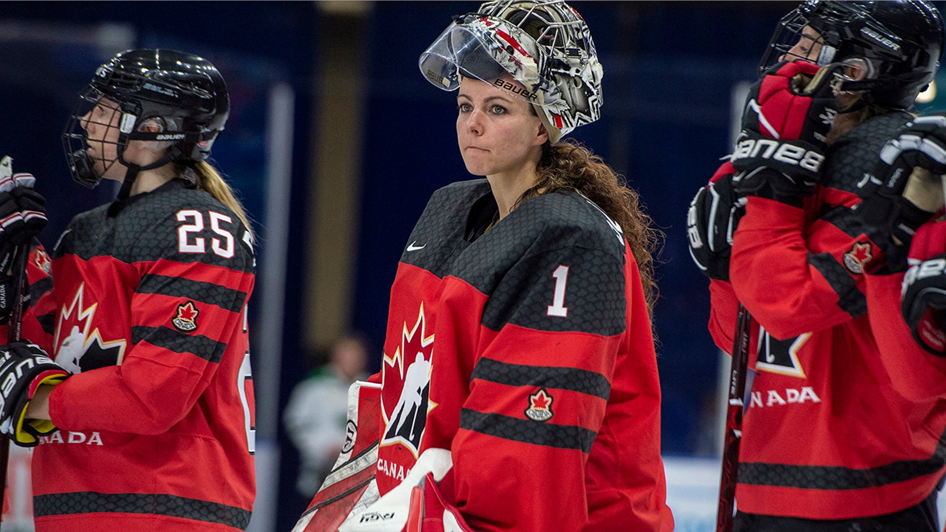 FILE - In this Nov. 10, 2018, file photo, Canada goaltender Shannon Szabados watch as U.S. players celebrate a win during the Four Nations Cup hockey gold-medal game in Saskatoon, Saskatchewan. (Liam Richards/The Canadian Press via AP)