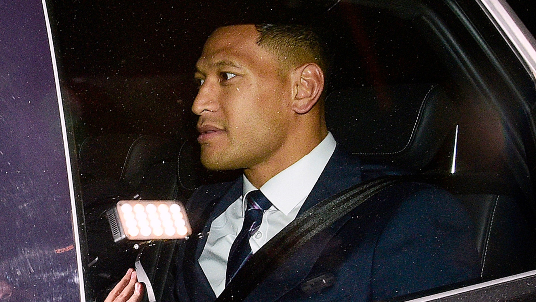 Australian rugby union player Israel Folau leaves a Code of Conduct hearing in Sydney, Sunday, May 5, 2019. The 30-year-old Folau appeared before the hearing to fight Rugby Australia's decision to terminate his contract after he posted in mid-April on social media that gay people, along with other "sinners," will face damnation unless they repent. (AAP Image/Bianca De Marchi)