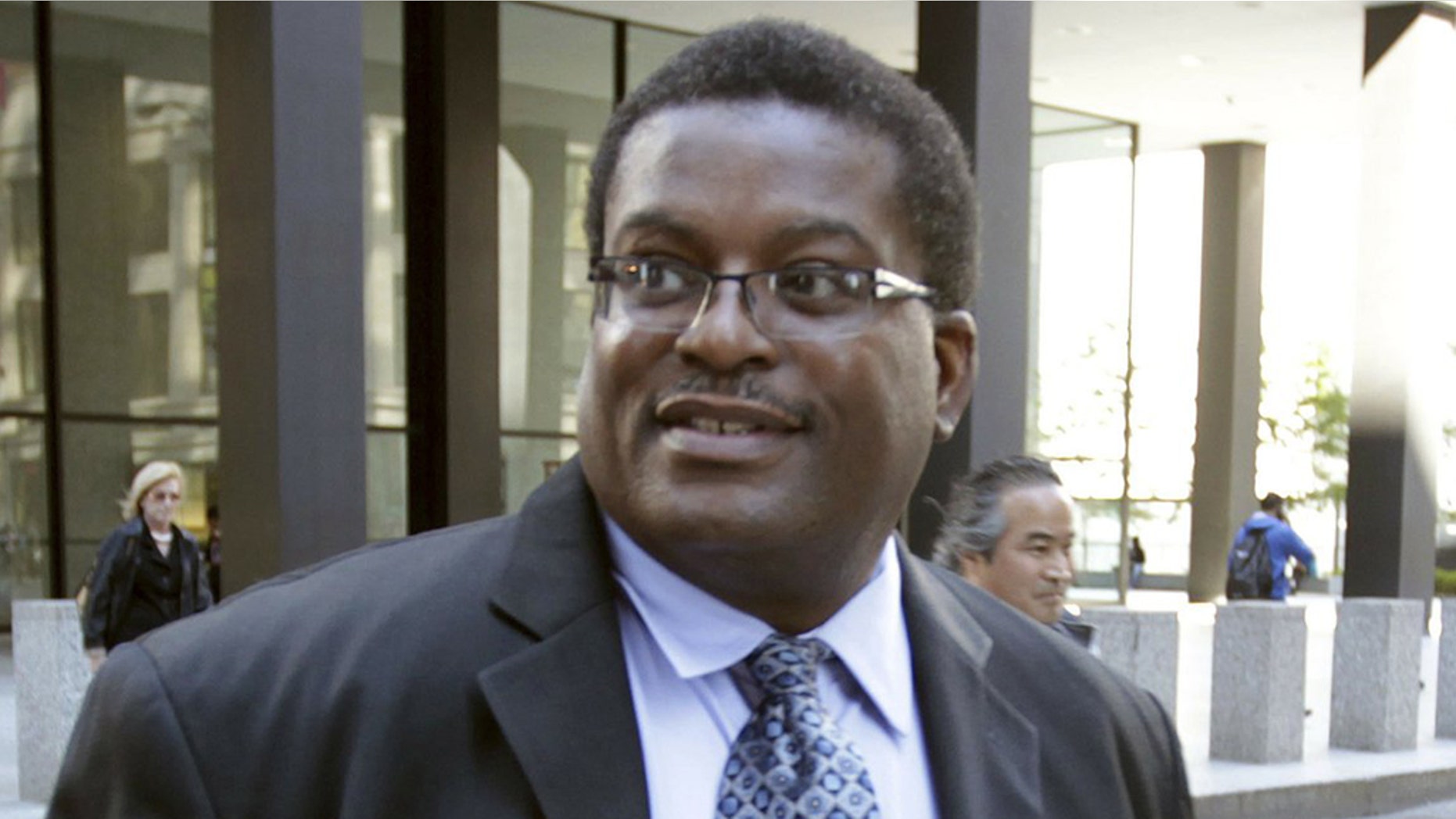 In this Oct. 9, 2013 photo, former Chicago Police Sgt. Ronald Watts, right, leaves the Dirksen U.S. Courthouse after being sentenced to 22 months in prison. Chicago has paid out more than $650 million in police misconduct cases over the past 15 years or so, and that expenditure is expected to increase yet more. (Phil Velasquez/Chicago Tribune via AP)