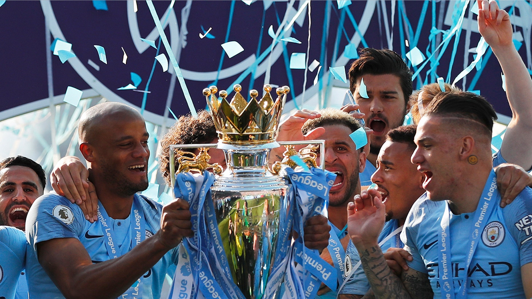Manchester City's Vincent Kompany lifts the English Premier League trophy after the English Premier League soccer match between Brighton and Manchester City at the AMEX Stadium in Brighton, England, Sunday, May 12, 2019. Manchester City defeated Brighton 4-1 to win the championship. (AP Photo/Frank Augstein)