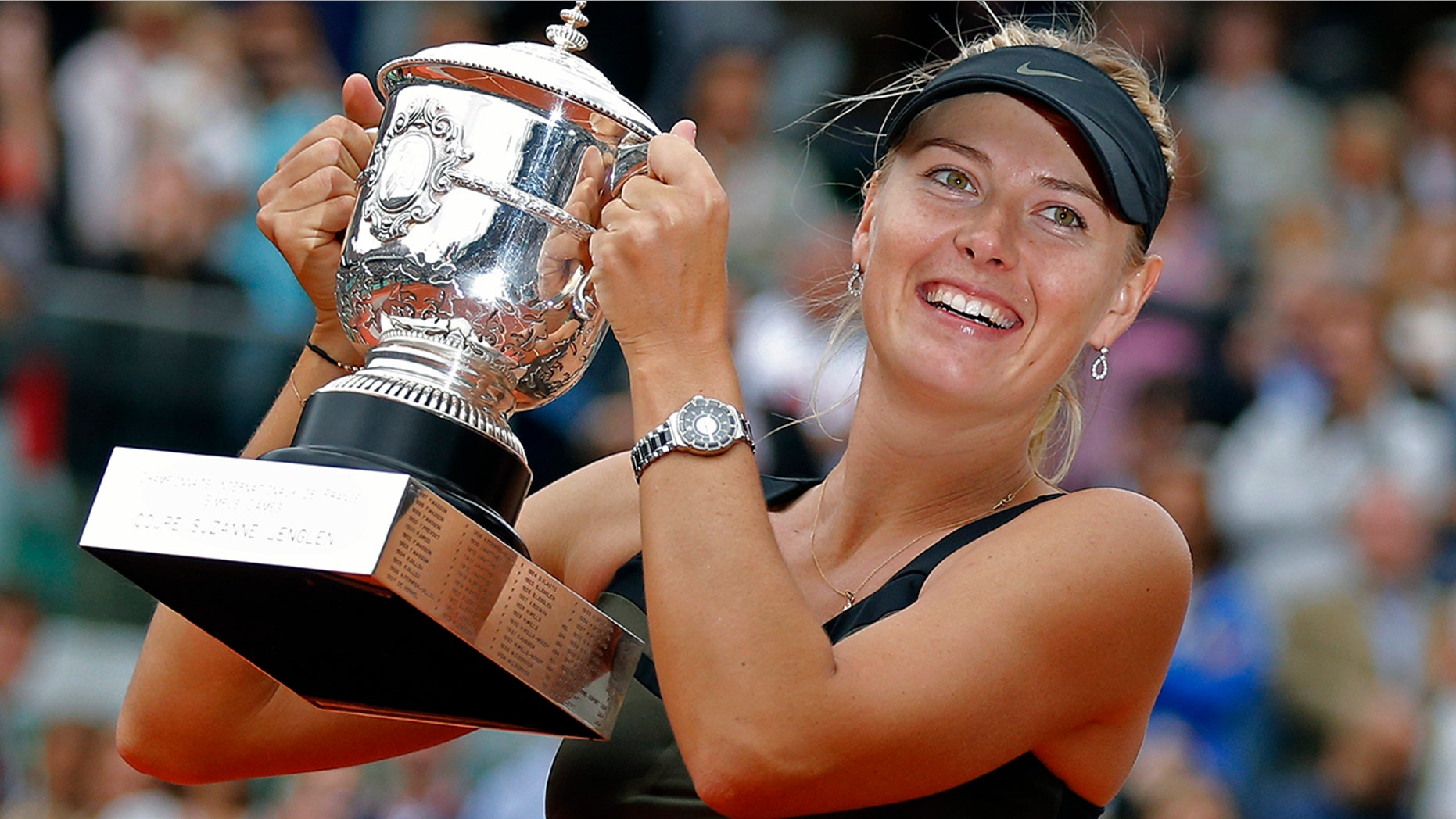 Maria Sharapova of Russia holds the trophy after winning the women's final match against Sara Errani of Italy at the French Open tennis tournament in Roland Garros stadium in Paris. (AP Photo/Michel Euler, File)