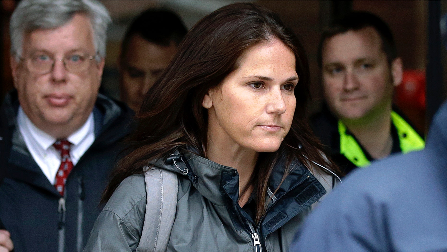 Former University of Southern California soccer coach Laura Janke departs federal court, Tuesday, May 14, 2019, in Boston, where she pleaded guilty to charges in a nationwide college admissions bribery scandal. (AP Photo/Steven Senne)