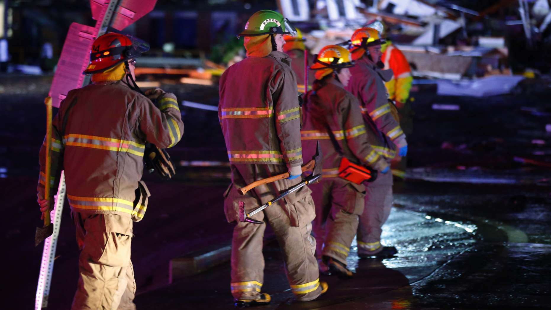 Firefighters walk to an area of debris from a hotel and a mobile home park in El Reno, Okla., Sunday, May 26, 2019, following a likely tornado touchdown late Saturday night. (AP Photo/Sue Ogrocki)