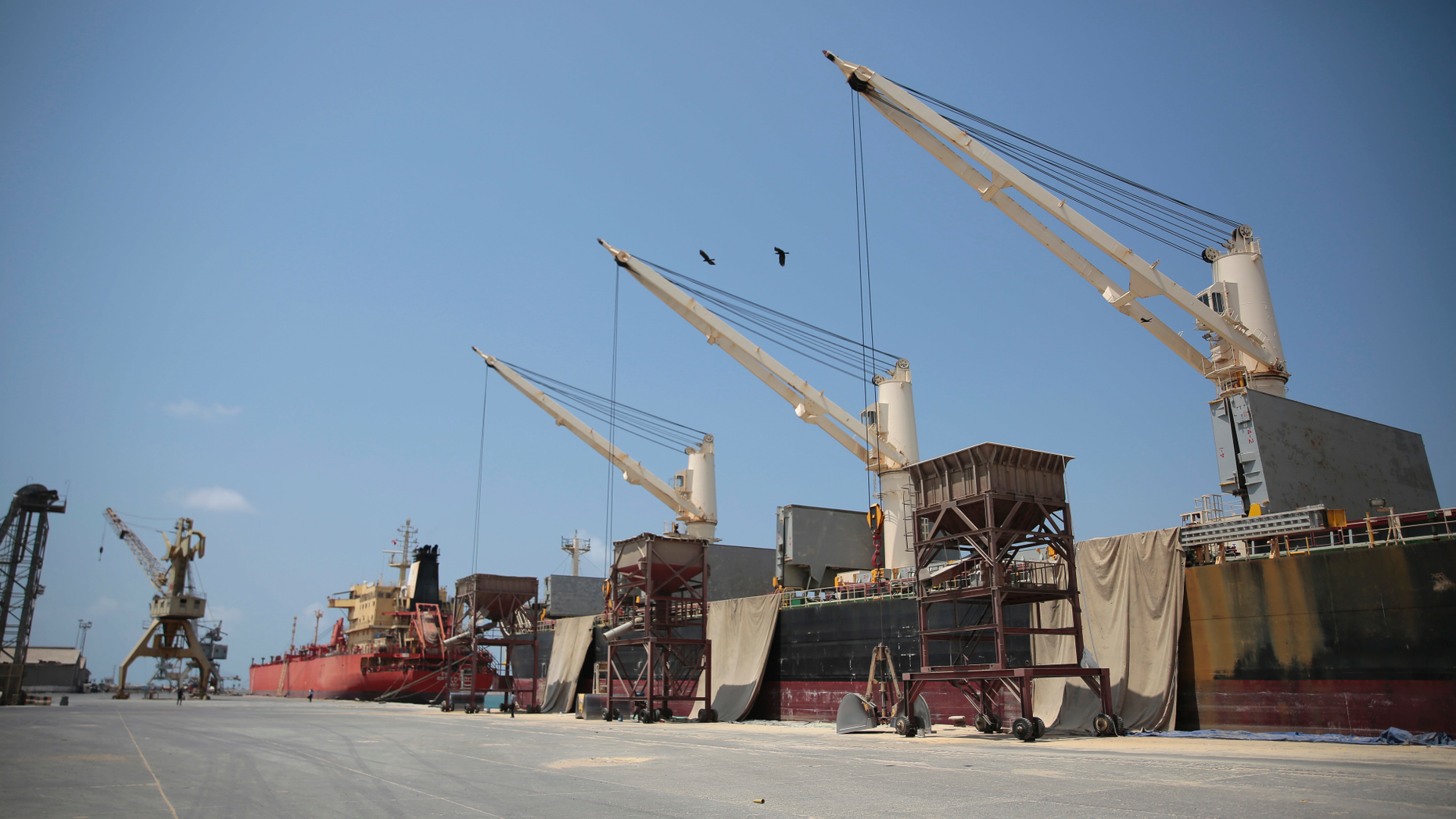 FILE - This Sept. 29, 2018 file photo shows idle cargo and oil tanker ships at the port of Hodeida, Yemen. On Saturday, May 11, 2019, Houthi rebels began a long-delayed withdrawal of their forces from the key port city, the group said, following the terms of a cease-fire. The U.N.-brokered agreement is aimed at alleviating the world’s worst humanitarian crisis. (AP Photo/Hani Mohammed)