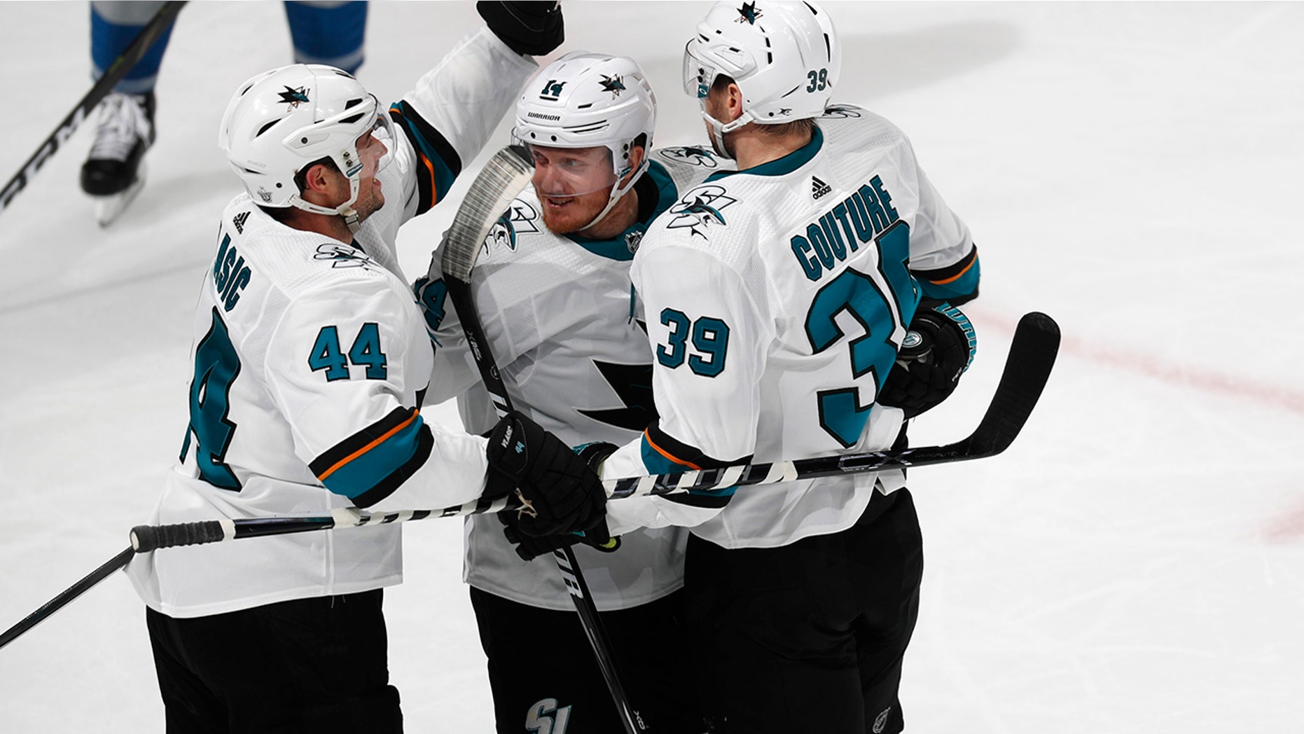 San Jose Sharks defenseman Marc-Edouard Vlasic, left, celebrates with center Gustav Nyquist and center Logan Couture, right, after his goal against the Colorado Avalanche during the third period of Game 3 of an NHL hockey second-round playoff series Tuesday, April 30, 2019, in Denver. The Sharks won 4-2. (AP Photo/David Zalubowski)