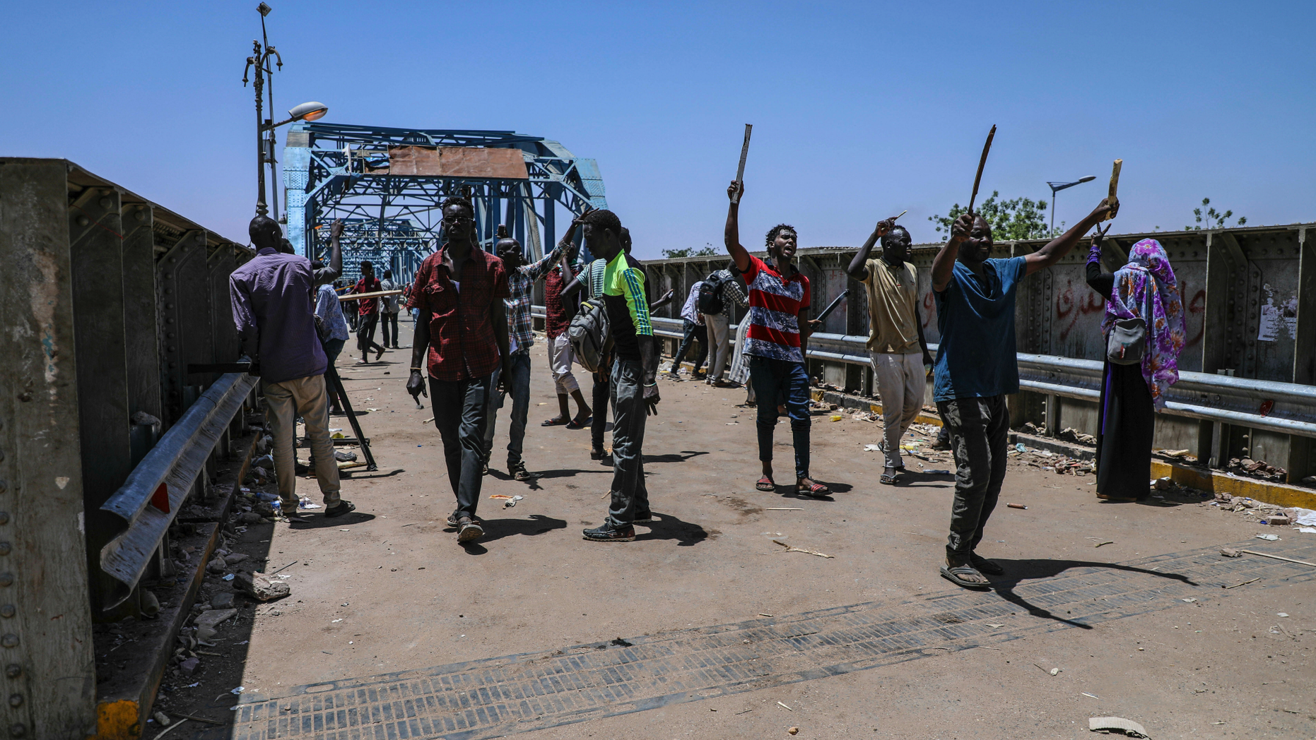 Protesters walk towards the sitin protest outside the Sudanese military headquarters, in Khartoum, Sudan, Tuesday, May 14, 2019. Sudanese protesters say security agents loyal to ousted President Omar al-Bashir attacked their sit-ins overnight, setting off clashes that left six people dead, including an army officer, and heightened tensions as the opposition holds talks with the ruling military council. Both the protesters and the transitional military council say the violence was instigated by al-Bashir loyalists from within the security forces. (AP Photo)