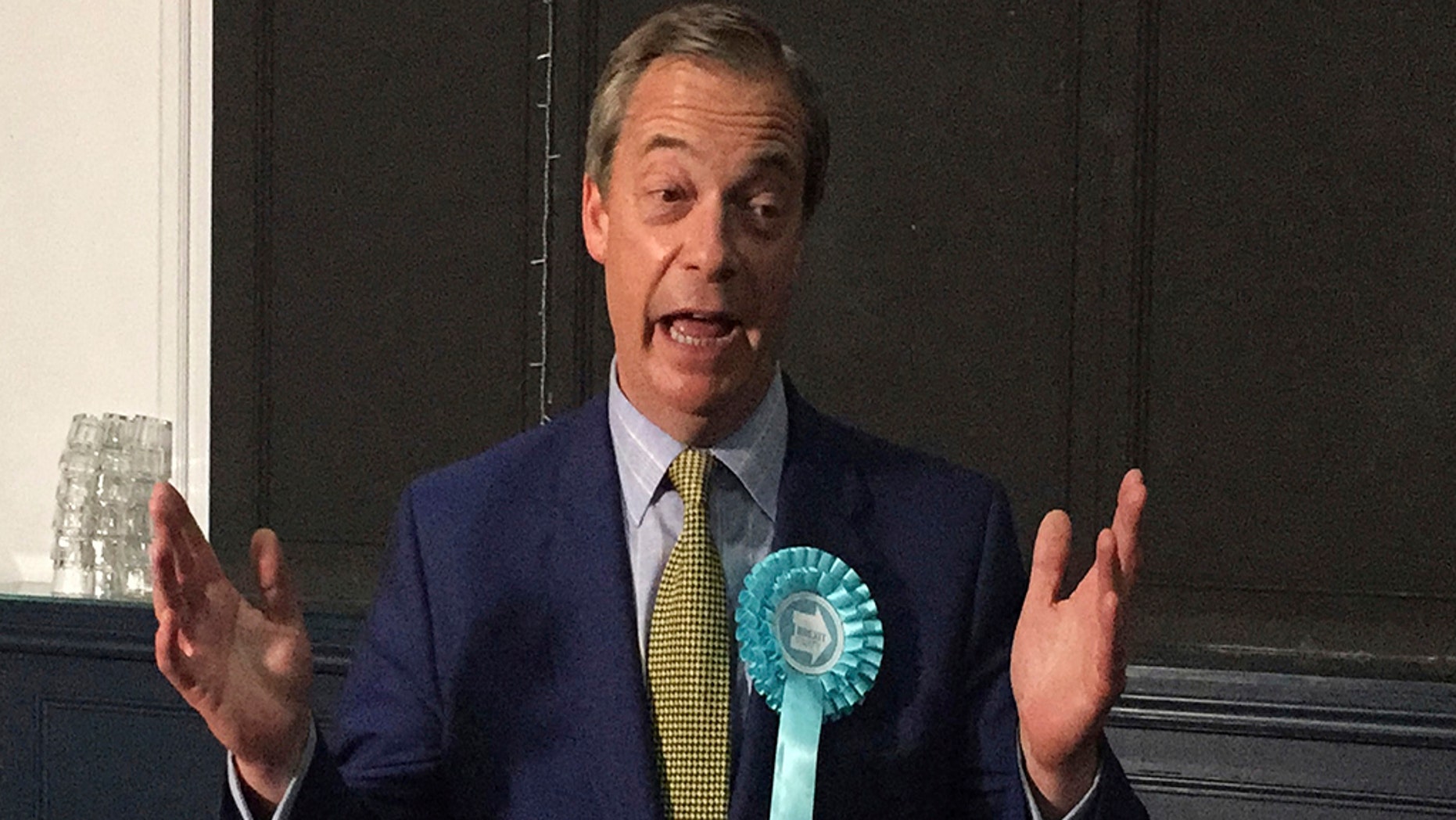 Brexit party leader Nigel Farage made gestures at his party's rally at the Corn Exchange in Edinburgh on Friday, May 17, 2019. (Tom Eden / PA via AP)
