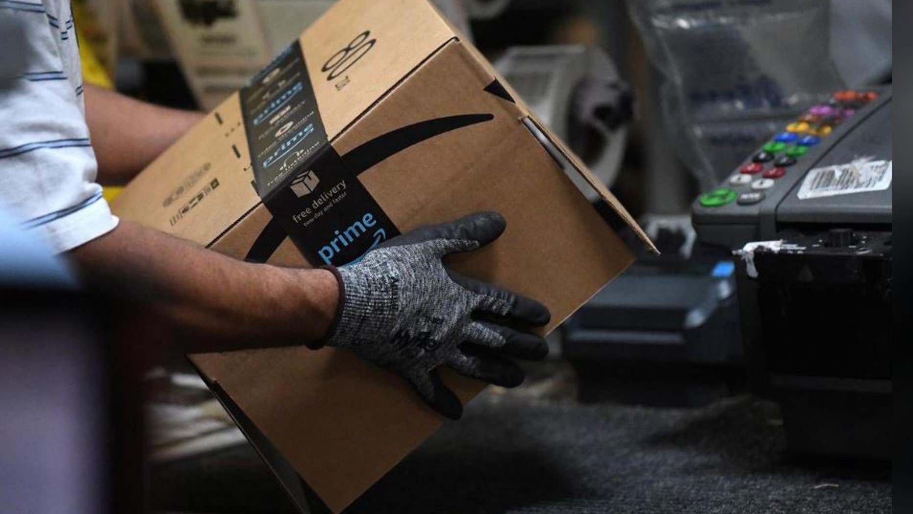 A worker assembles a box for delivery at the Amazon fulfillment center in Baltimore, Maryland, U.S., April 30, 2019.