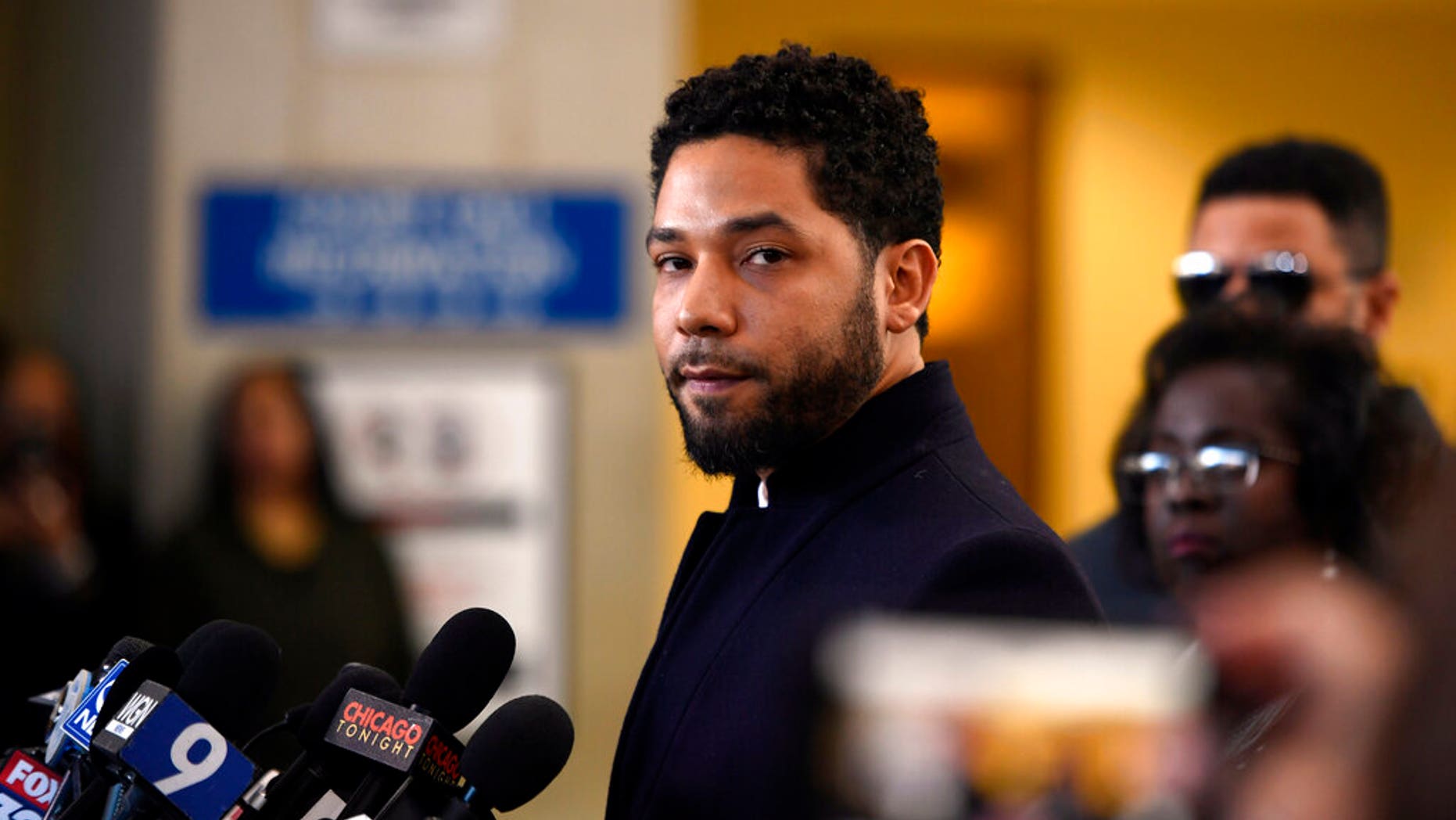 FILE - In this March 26, 2019 file photo, Actor Jussie Smollett talks to the media before leaving Cook County Court after his charges were dropped, in Chicago. Chicago's top prosecutor has released 2,000 documents in the Jussie Smollett's case and explained she recused herself from an investigation into his claim he'd been the target of a racist, anti-gay attack solely because of false rumors she was related to the "Empire" actor. The Friday, May 31, 2019 statement from Cook County State's Attorney Kim Foxx came two months after her office's suddenly dropped all charges against Smollett that accused him of staging the attack on himself. (AP Photo/Paul Beaty, File)
