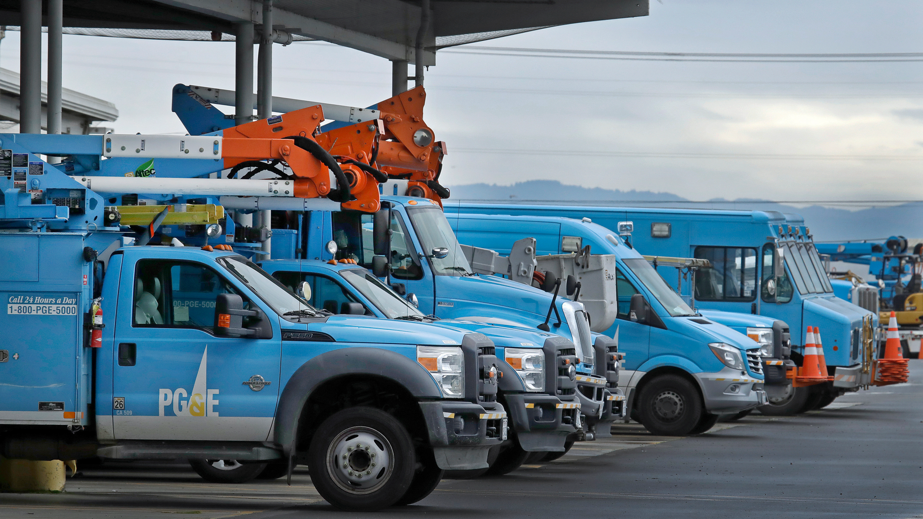 FILE - In this Jan. 14, 2019, file photo, Pacific Gas & Electric vehicles are parked at the PG&E Oakland Service Center in Oakland, Calif. The year's first fire danger warning in Northern California is putting Pacific Gas & Electric on alert. The utility said starting Saturday, June 8, 2019, it might turn off power to thousands of customers in areas north of San Francisco and in the Sierra foothills to help reduce the risk of fire. (AP Photo/Ben Margot, File)