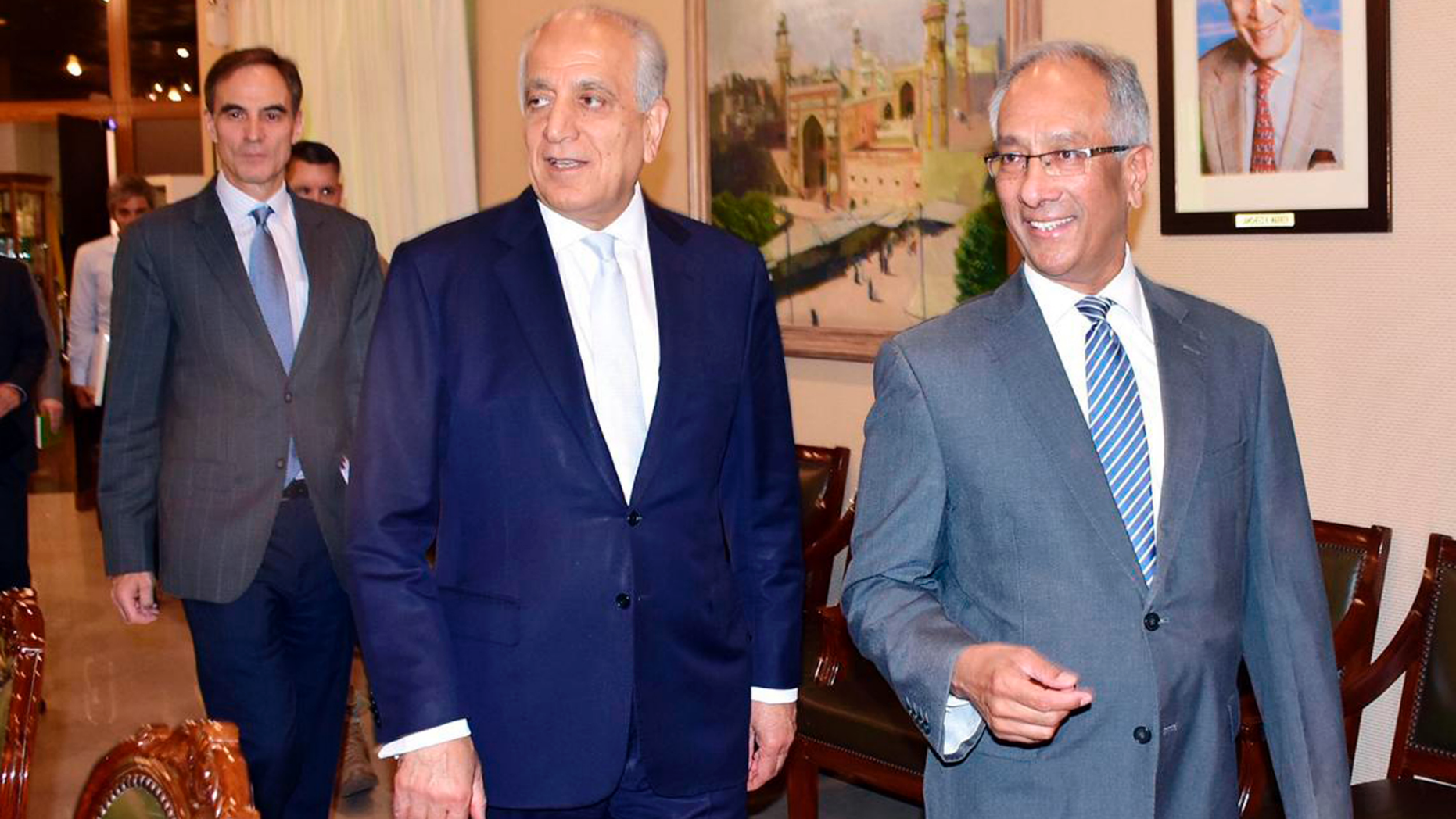 In this photo released by the Foreign Office, Pakistan's Foreign Ministry official Aftab Khokhar, right, escorts visiting Special Representative for Afghanistan Reconciliation Zalmay Khalilzad, center, for talks at the Foreign Office in Islamabad, Pakistan, Sunday, June 2, 2019. Khalilzad has met Pakistani officials to find a peaceful solution to neighboring Afghanistan's war. (Pakistan Foreign Office via AP)