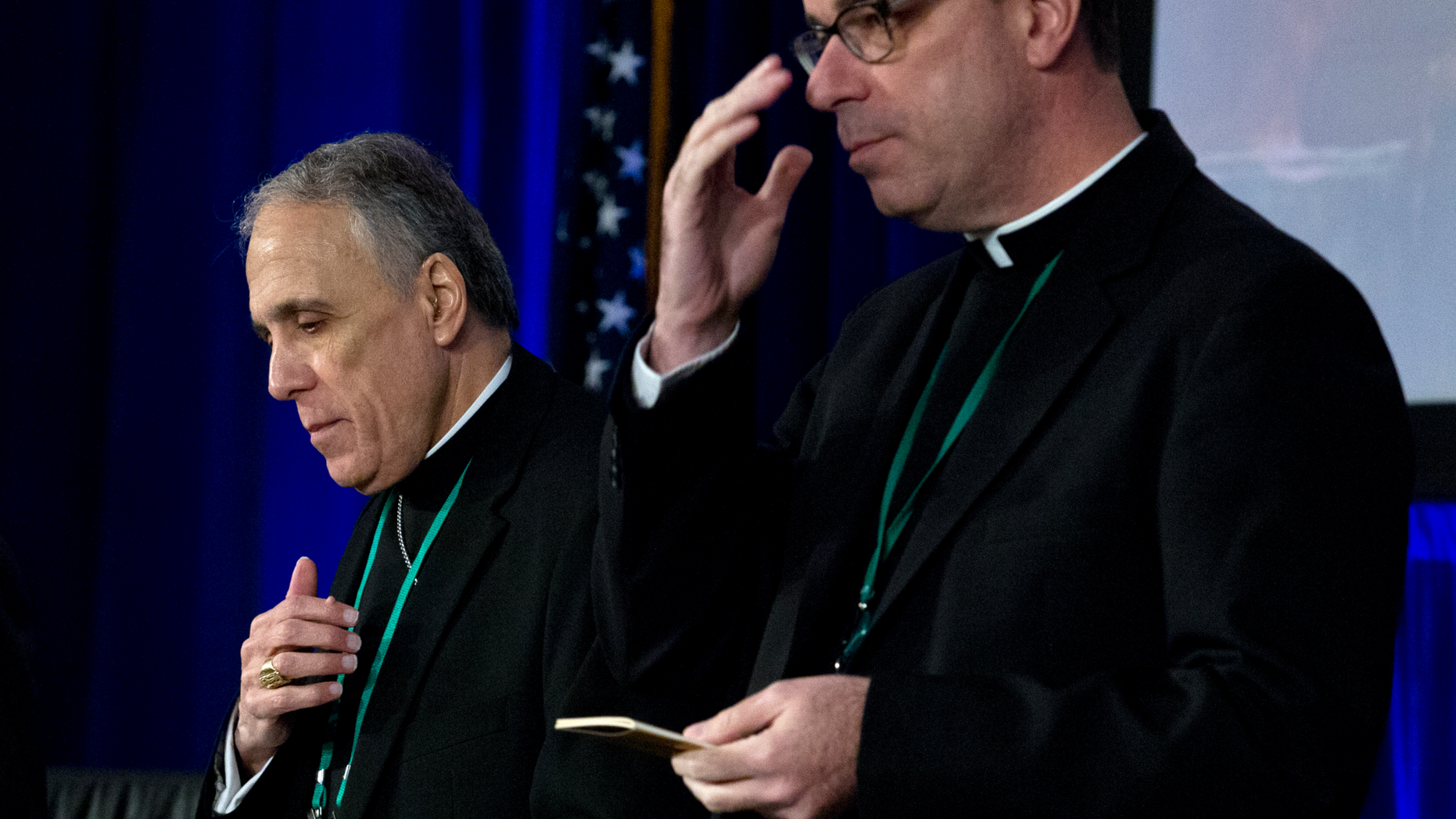 Cardinal Daniel DiNardo, left, of the Archdiocese of Galveston-Houston, president of the United States Conference of Catholic Bishops accompanied by Rev. J. Brian Bransfield, participates in a morning prayer, during the United States Conference of Catholic Bishops (USCCB), 2019 Spring meetings in Baltimore, Tuesday, Jun 11, 2019. (AP Photo/Jose Luis Magana)