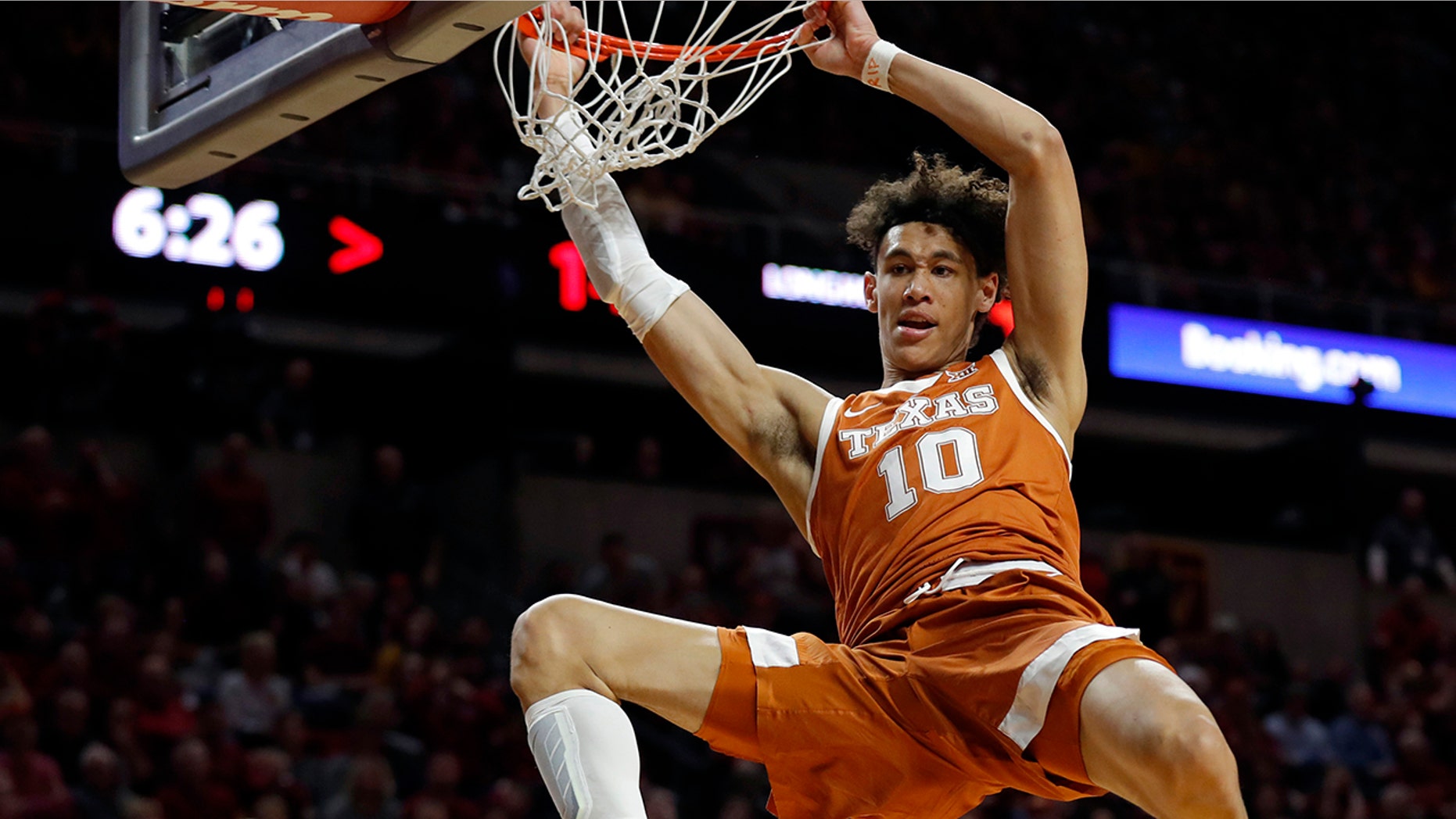 FILE - In this Feb. 2, 2019, file photo, Texas forward Jaxson Hayes (10) dunks the ball over Iowa State guard Nick Weiler-Babb, left, during the first half of an NCAA college basketball game, in Ames, Iowa. Hayes needed only a year at Texas to put himself at the front of the class of big men in the NBA draft coming Thursday, June 20, 2019. (AP Photo/Charlie Neibergall, File)
