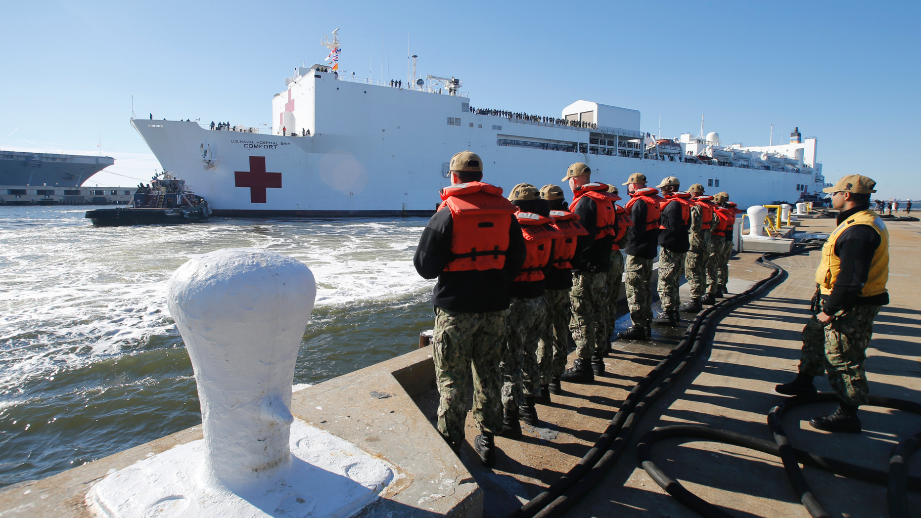 FILE - In this Dec. 18, 2018 file photo, line handlers wait as the US Navy Hospital Ship USNS Comfort arrives pier side at Naval Station Norfolk, in Norfolk , Va., after an 11-week medical support mission to South and Central America. The USNS Comfort begins on Friday, June 14, 2019, a five-month medical mission that will include 11 countries impacted by the flow of Venezuelan migration. The ship will depart Friday from Norfolk, Virginia (AP Photo/Steve Helber, File)