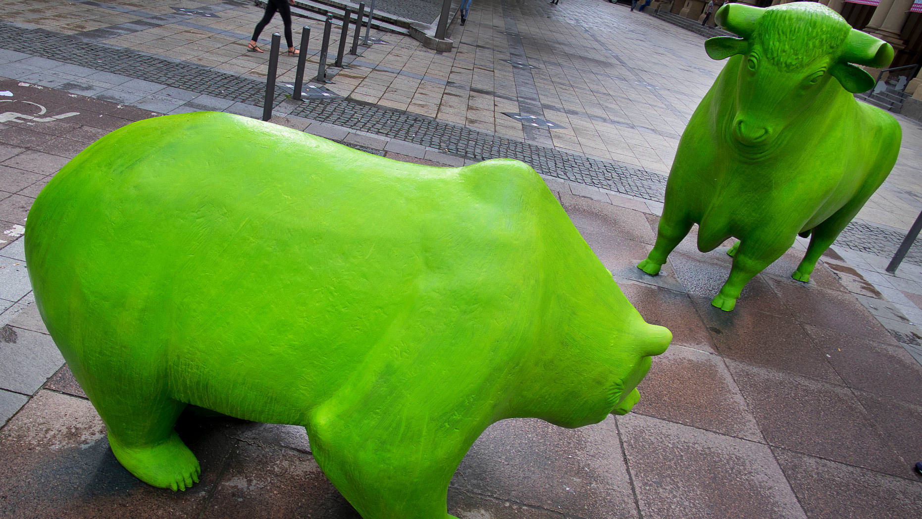 The bull and the bear in front of the purse are painted green in Frankfurt, Germany, on Monday, June 3, 2019. They were painted on the occasion of the next 