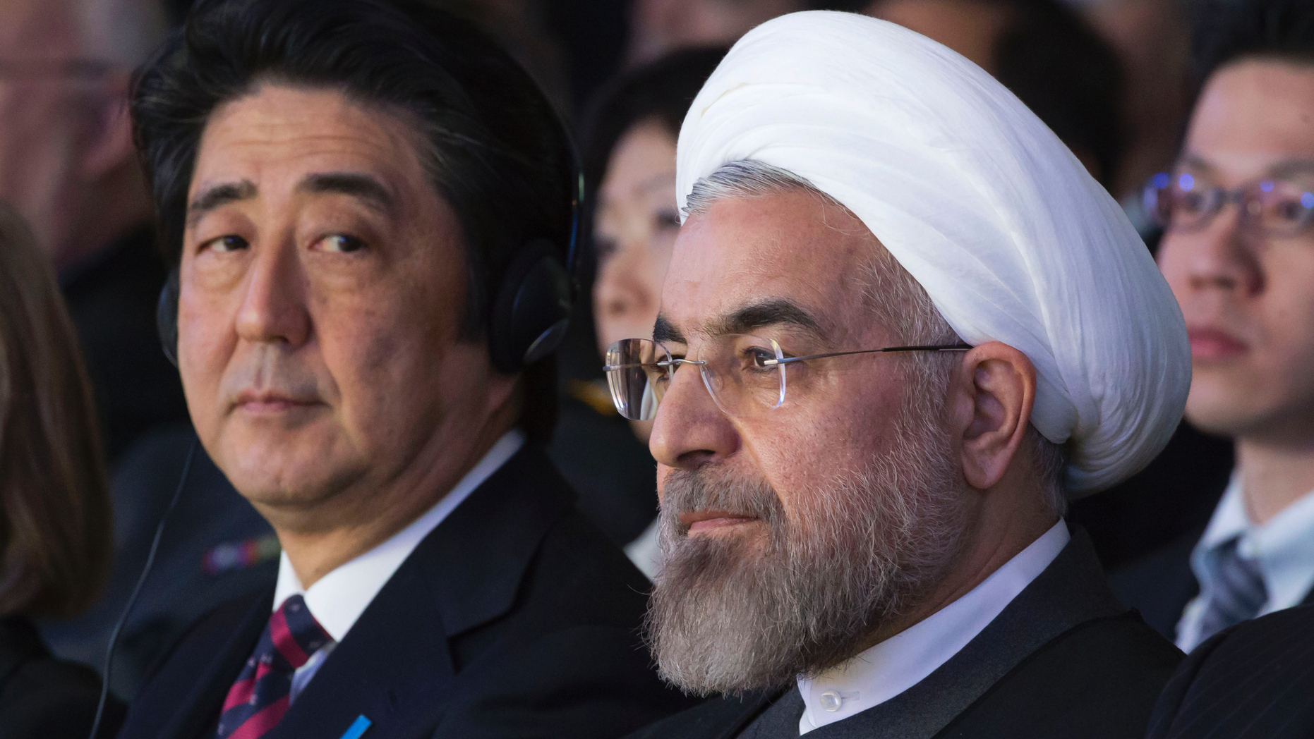 FILE - In this Jan. 22, 2014 file photo, Japanese Prime Minister Shinzo Abe, left, and Iranian President Hassan Rouhani, attend a session of the World Economic Forum in Davos, Switzerland. Abe's trip to Tehran on Wednesday, June 12, 2019, represents the highest-level effort yet to de-escalate tensions between the U.S. and Iran. The visit comes as Iran appears poised to break the 2015 nuclear deal it struck with world powers that America earlier abandoned. (AP Photo/Michel Euler, File)