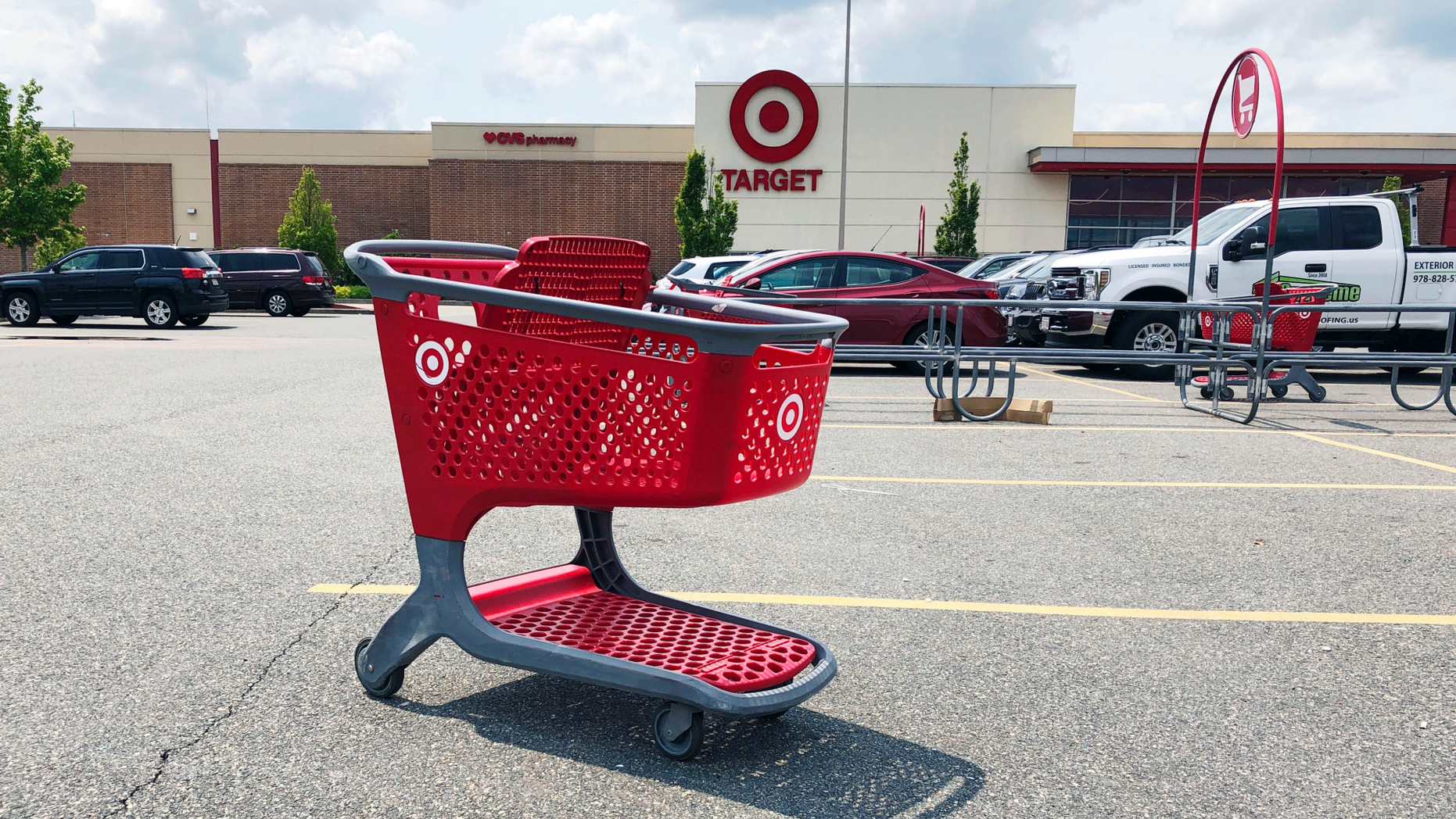FILE - In this June 3, 2019, file photo a shopping cart sits in the parking lot of a Target store in Marlborough, Mass. On Friday, June 14, the Commerce Department releases U.S. retail sales data for May. (AP Photo/Bill Sikes, File)