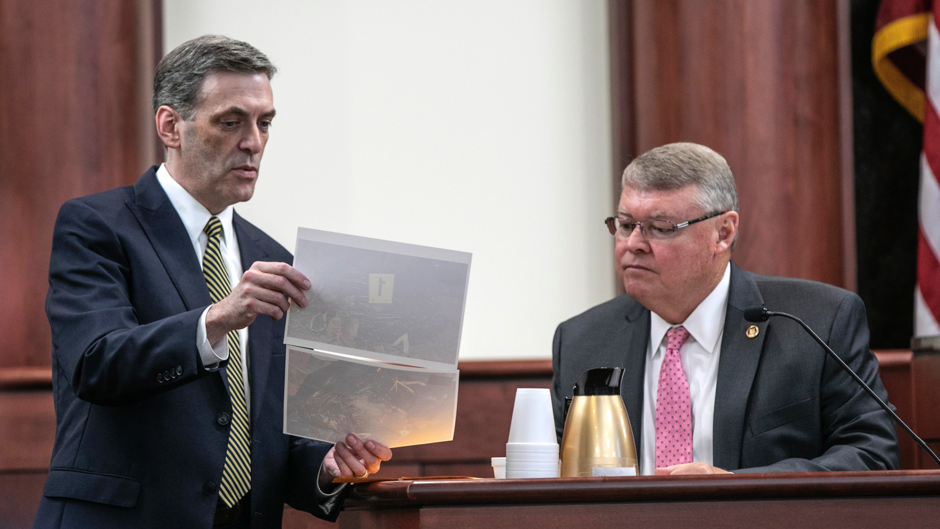 Solicitor Rick Hubbard shows former SLED investigator David Lawrence photographs in evidence from the scene where the Jones children were located, during the sentencing phase of the trial of Timothy Jones Jr. in Lexington, S.C., Thursday, June 6, 2019. Timothy Jones, Jr. has been found guilty of killing his 5 young children in 2014. (Tracy Glantz/The State via AP, Pool)