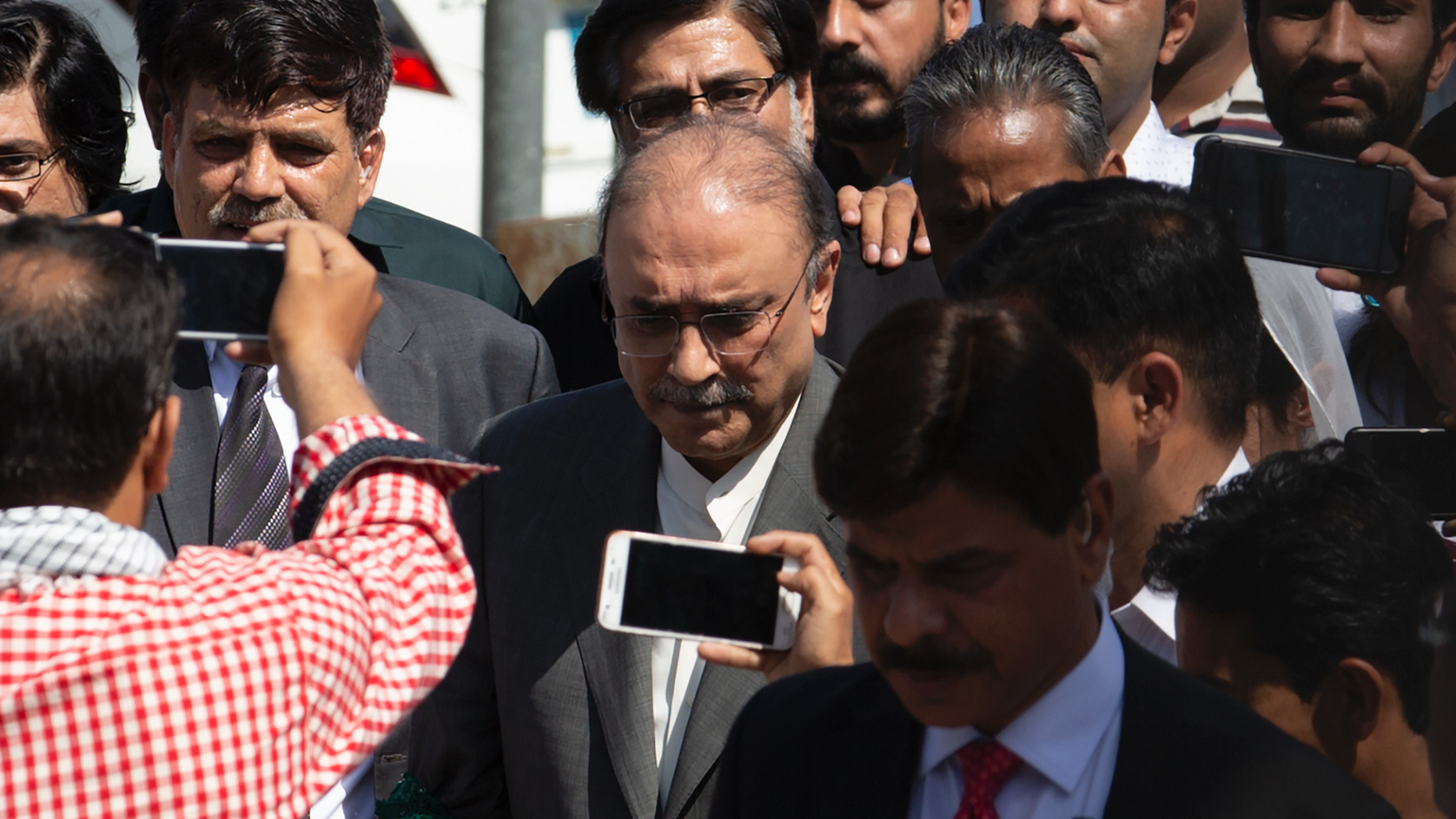 Former Pakistani president and currently a lawmaker in Parliament and leader of Pakistan People's party, Asif Ali Zardari, center, leaves the High Court building, in Islamabad, Pakistan, Monday, June 10, 2019. A Pakistani court has rejected a request by Zardari and his sister Faryal Talpur, for an extension of their bail that would allow them to remain free despite facing a multimillion-dollar money laundering case. (AP Photo/B.K. Bangash)