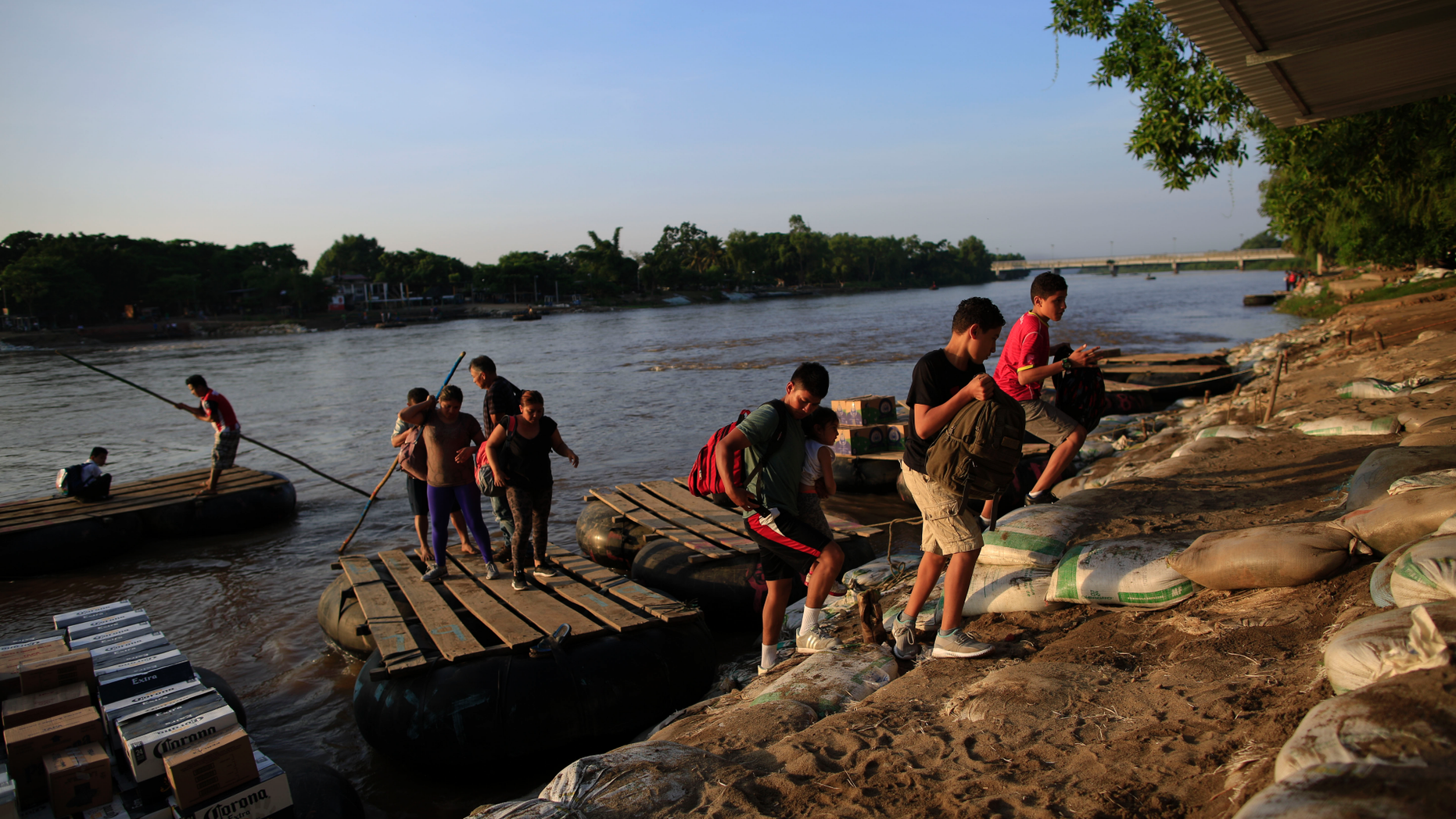 A group of migrants arriving from Guatemala disembark from a raft in Ciudad Hidalgo, Mexico, Tuesday, June 18, 2019. The number of migrants taking rafts at the busy Ciudad Hidalgo crossing point appears to have decreased significantly in recent days amid fears of a pending deployment of the National Guard along the southern border. (AP Photo/Rebecca Blackwell)