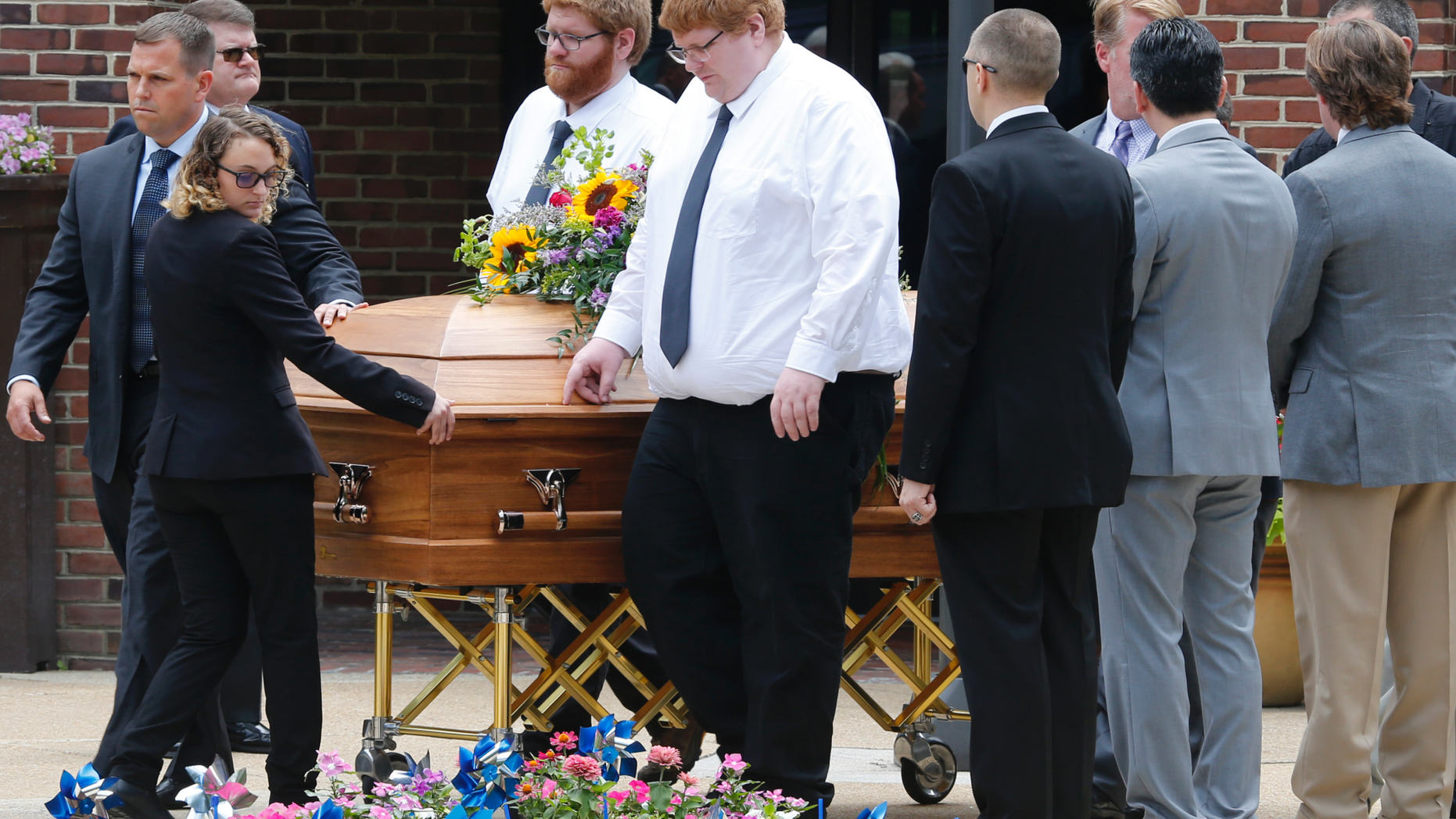 The casket of Virginia Beach shooting victim Katherine Nixon is wheeled to a hearse after a funeral service at St. Gregory The Great Catholic Church in Virginia Beach, Va Thursday, June 6, 2019. Nixon was killed along with eleven others during a mass shooting last Friday. (AP Photo/Steve Helber)