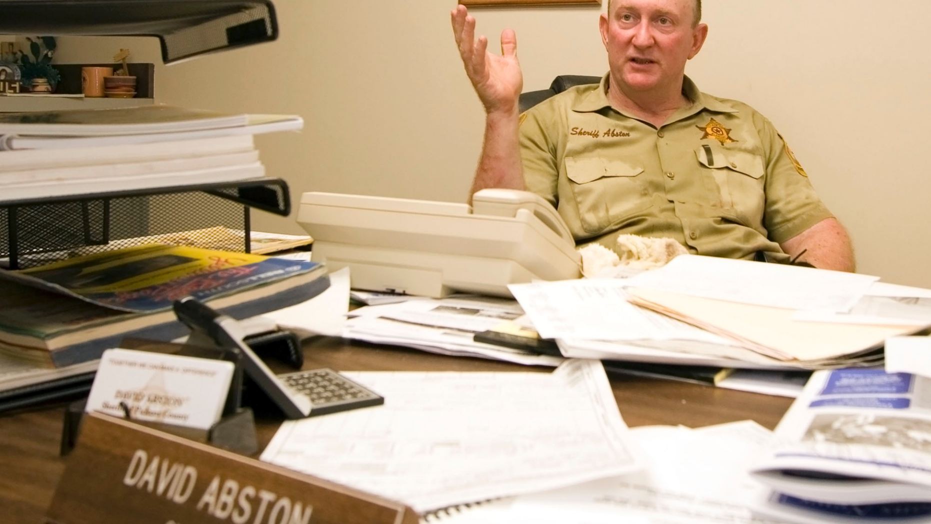 In this July 7, 2006 photo, Pickens County Sheriff David Abston speaks with reporters about a jailbreak in Carrollton, Ala. Court records show Abston was arrested Friday, June 14, 2019, and is pleading guilty to fraud and filing a false tax return. He is charged with scamming a food bank and his own church to pocket thousands under a law that let state sheriffs profit from feeding prisoners. (Dusty Compton/The Tuscaloosa News via AP)