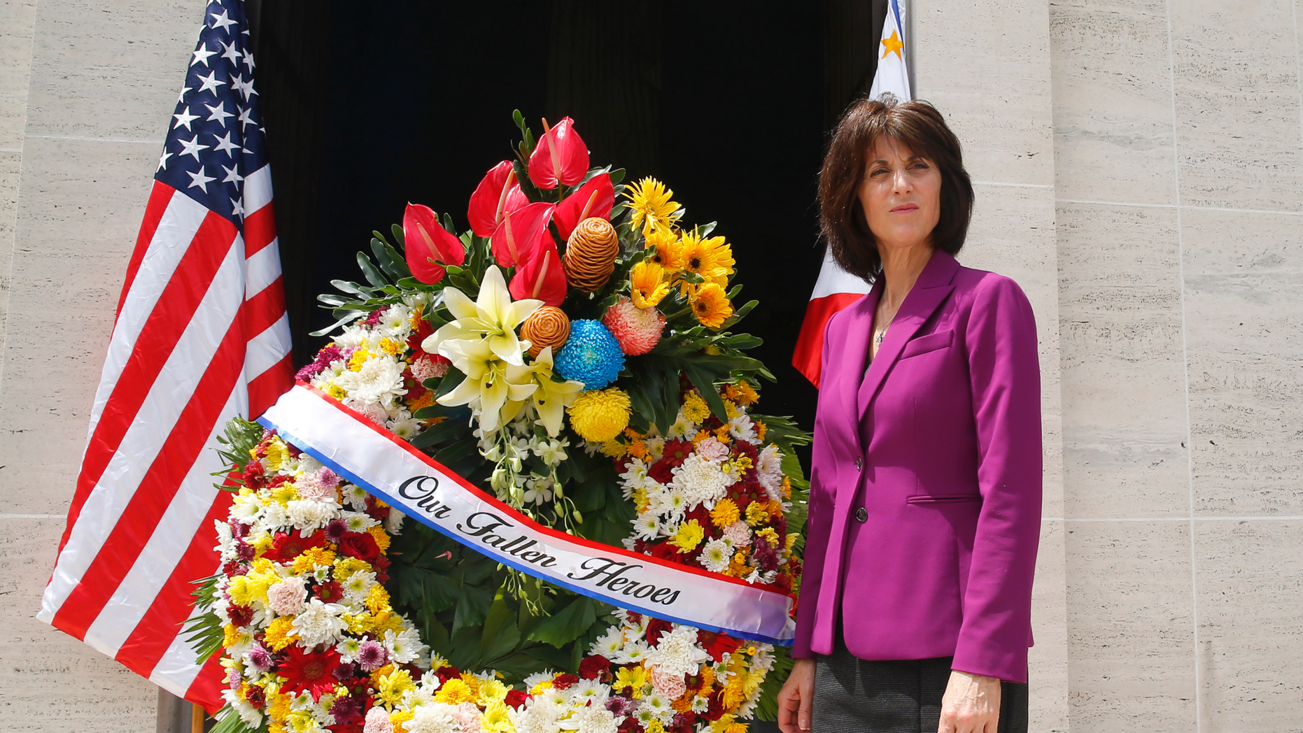 Denise Natali, U.S. Assistant Secretary Bureau of Conflict and Stabilization Operations, stands beside a wreath during a wreath-laying ceremony for the more than 17,000 US troops killed during WWII at the American Cemetery Tuesday, June 4, 2019 in suburban Taguig city east of Manila, Philippines. Natali is here to discuss with Philippine security officials a new program to help thwart efforts by Muslim extremists to recruit and mobilize followers after a bloody siege by jihadists aligned with the Islamic State group. (AP Photo/Bullit Marquez)