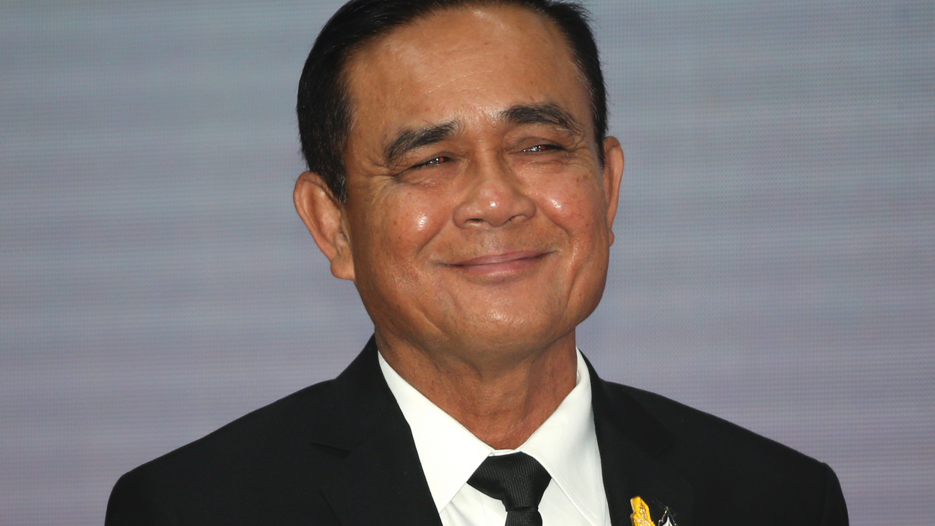 FILE - In this 5, 2019, file photo, Thailand's Prime Minister Prayuth Chan-ocha smiles after the speech for the opening ceremony of Anti-Human Trafficking Day in Bangkok, Thailand. On Tuesday, Prayuth has been officially proclaimed prime minister after the king endorsed Parliament’s vote to allow him to keep the position. (AP Photo/Sakchai Lalit, File)