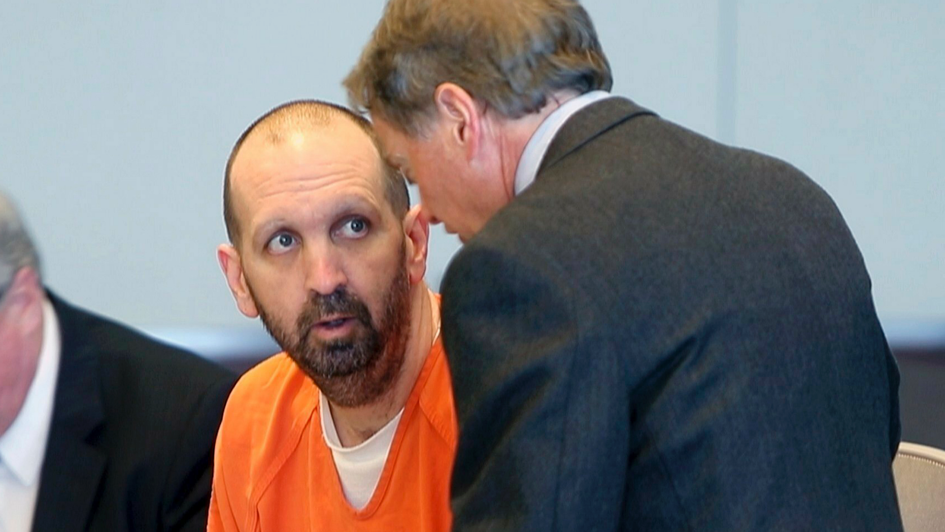 FILE - In this March 14, 2017, file photo, Craig Hicks, center, charged with the murder of three Muslim students in Chapel Hill, N.C., listens to with attorney Steve Freedman as he makes an appearance in a Durham County courtroom in Durham, N.C. Hicks is expected Wednesday, June 12, 2019, to enter a plea in court in Durham, more than four years after the slayings, which the victims’ families blamed on bigotry. (Chris Seward/The News & Observer via AP, FIle)