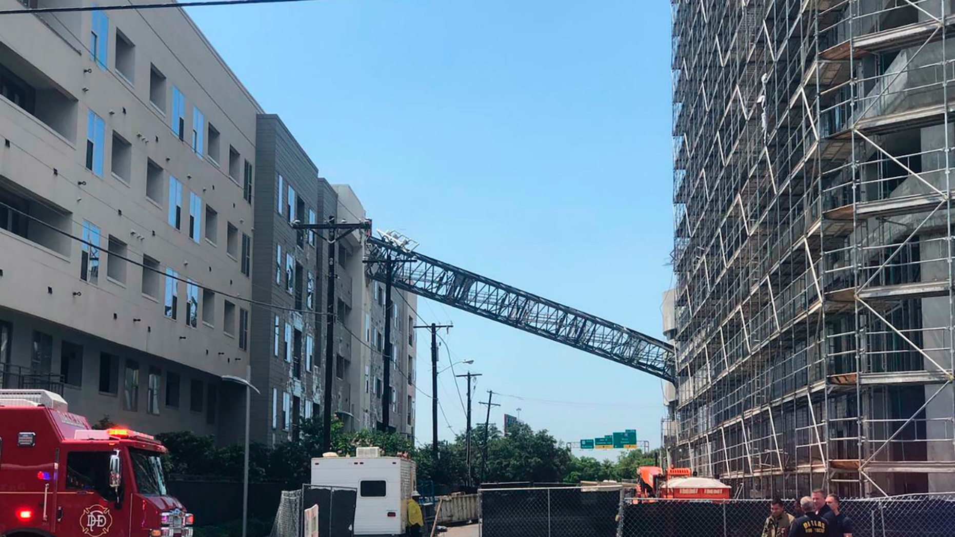 This photo taken and provided by Michael Santana shows a construction crane toppling on an apartment building as it was buffeted by high winds during a storm in Dallas, Texas, Sunday, June 9, 2019. (Michael Santana via AP)