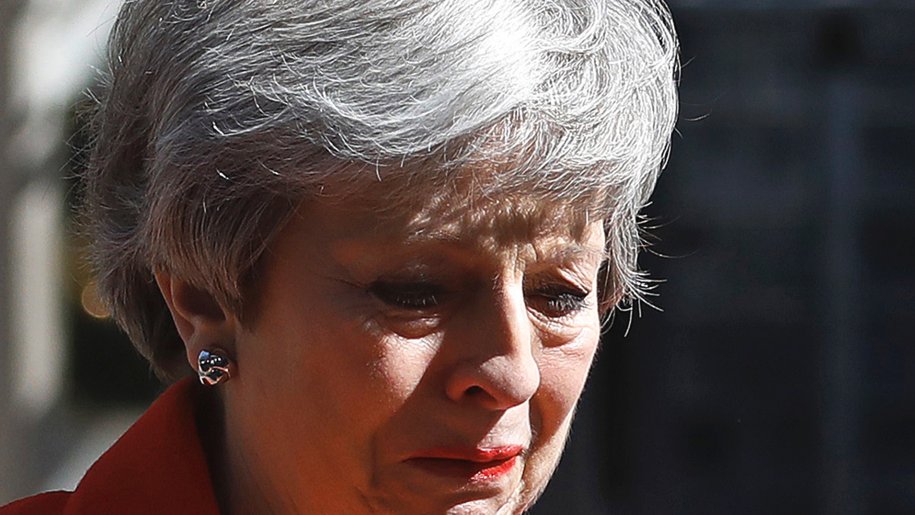 FILE - In this Friday, May 24, 2019 file photo, British Prime Minister Theresa May reacts as she turns away after making a speech in the street outside 10 Downing Street in London, England. May formally steps down as Conservative Party leader on Friday, June 7, 2019 defeated by the Brexit conundrum. No public event is planned to mark the occasion as May’s time at the helm ends, not with a bang but a whimper. (AP Photo/Alastair Grant, File)