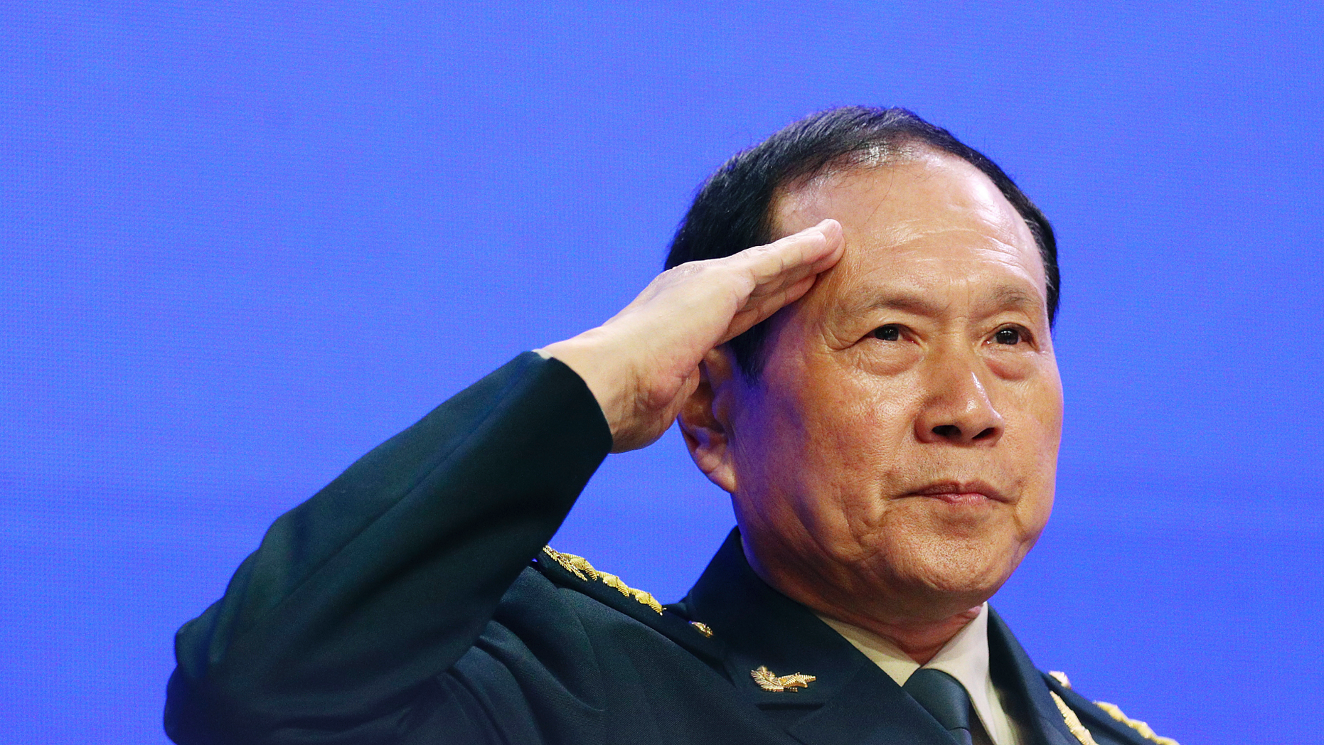 Chinese Defense Minister Gen. Wei Fenghe salutes attendees ahead of the fourth plenary session of the 18th International Institute for Strategic Studies (IISS) Shangri-la Dialogue, an annual defense and security forum in Asia, in Singapore, Sunday, June 2, 2019. (AP Photo/Yong Teck Lim)