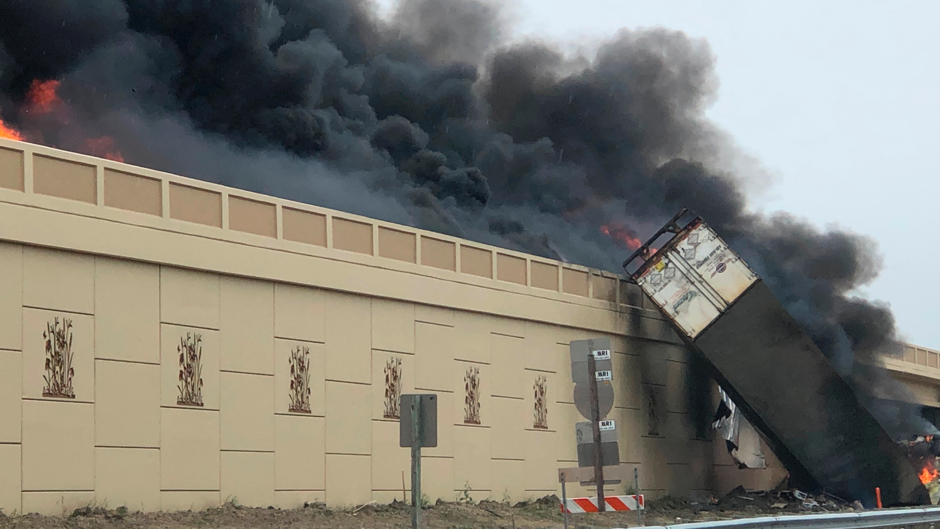 Smoke billows from a semi after a deadly crash on Interstate 94 in Caledonia, Wis, Wednesday, June 19, 2019. Authorities said the semi crashed and exploded and ignited other vehicles on the interstate in southeastern Wisconsin. (Katelyn Planka via AP)