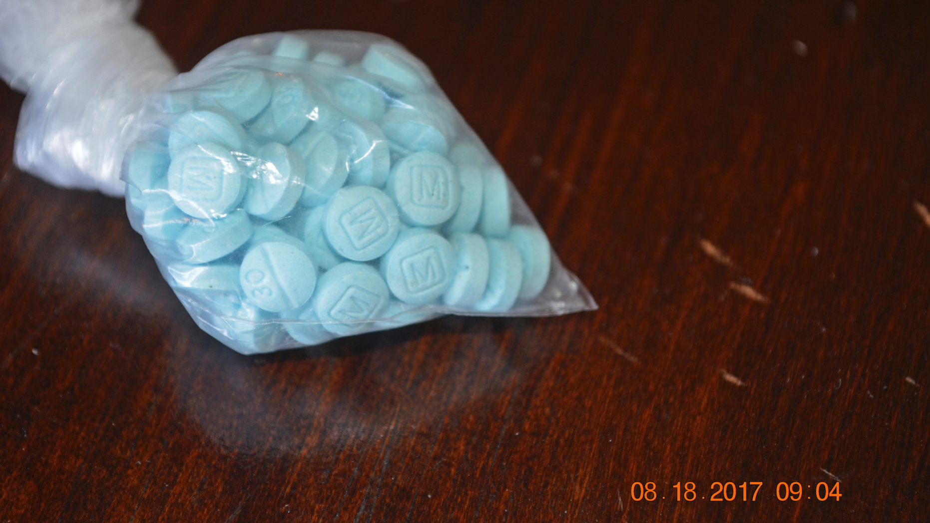 FILE - This undated file photo provided by the U.S. Drug Enforcement Administration's Phoenix Division shows a closeup of fentanyl-laced sky blue pills. Police in small city on the U.S.-Mexico border say three students have been arrested for possessing fentanyl pills on campus, including one who had over 3,000 pills with her. San Luis, Arizona, police say two 18-year-old girls and a 16-year-old boy were arrested Wednesday, June 5, 2019 after an on-campus officer found them with pills. (Drug Enforcement Administration via AP, File)