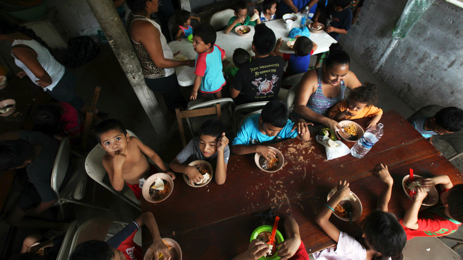 FILE - In this May 30, 2019 file photo, Honduran migrant children eat a meal at the Jesus el Buen Pastor del Pobre y el Migrante shelter in Tapachula, Chiapas state, Mexico. The federal government will be opening a facility at an Army base in Oklahoma to house migrant children and is considering a customs port in southern New Mexico as another option as existing shelters are overwhelmed. The Office of Refugee Resettlement said Tuesday, June 11, 2019 it's dealing with a dramatic spike in the number of children crossing the border without parents. (AP Photo/Marco Ugarte, File)