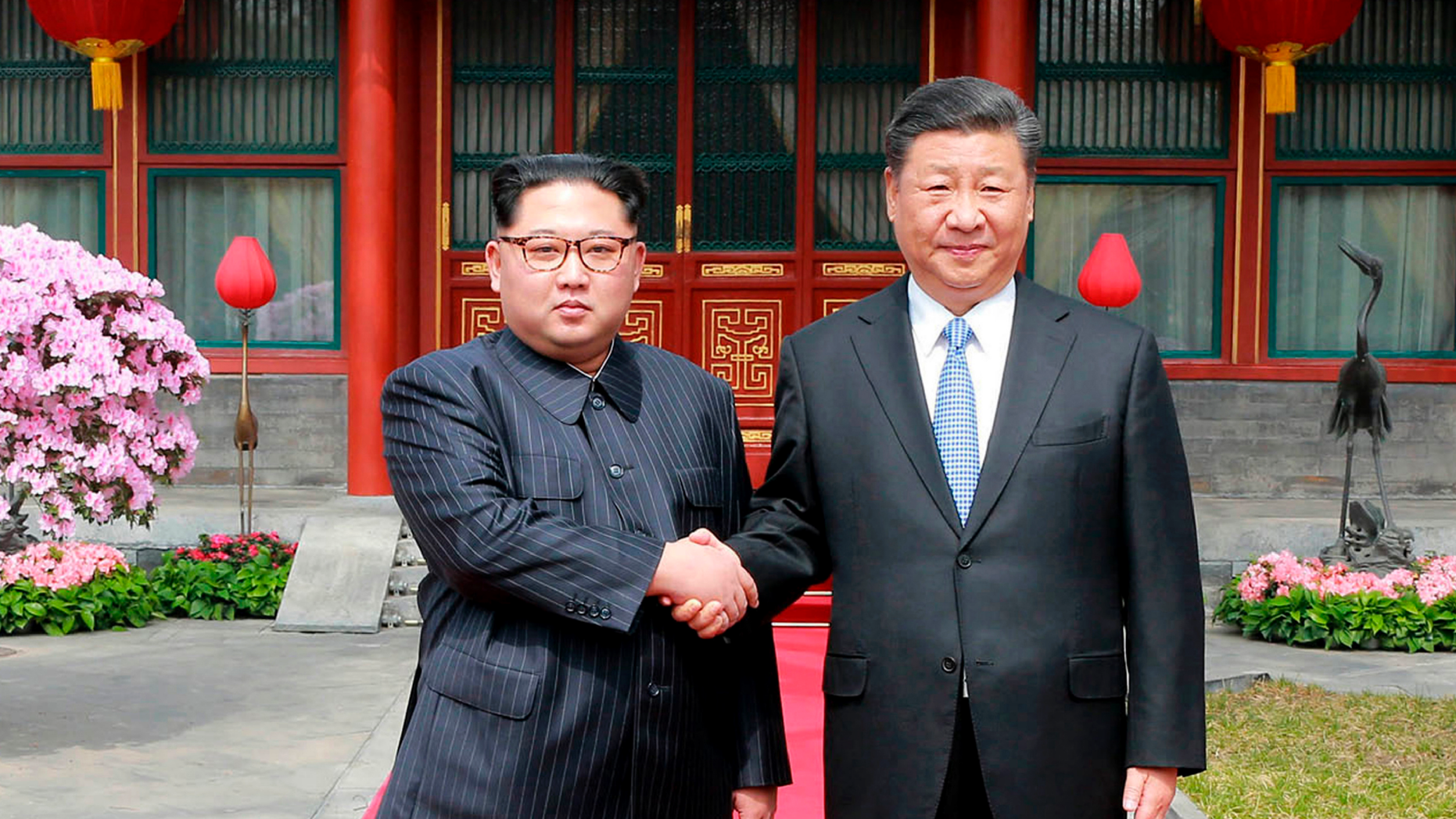 FILE - In this March 27, 2018, file photo, North Korean leader Kim Jong Un, left, shakes hands with Chinese counterpart Xi Jinping at Diaoyutai State Guesthouse in Beijing, China. Kim’s fifth meeting with Xi continues his ambitious diplomatic outreach that has included summits with the leaders of the United States, South Korea and Russia in the past year and a half. Experts say Kim is attempting to form a united front with North Korea’s main ally China to strengthen his leverage in the stalled nuclear negotiations with the United States. (Korean Central News Agency/Korea News Service via AP, File)
