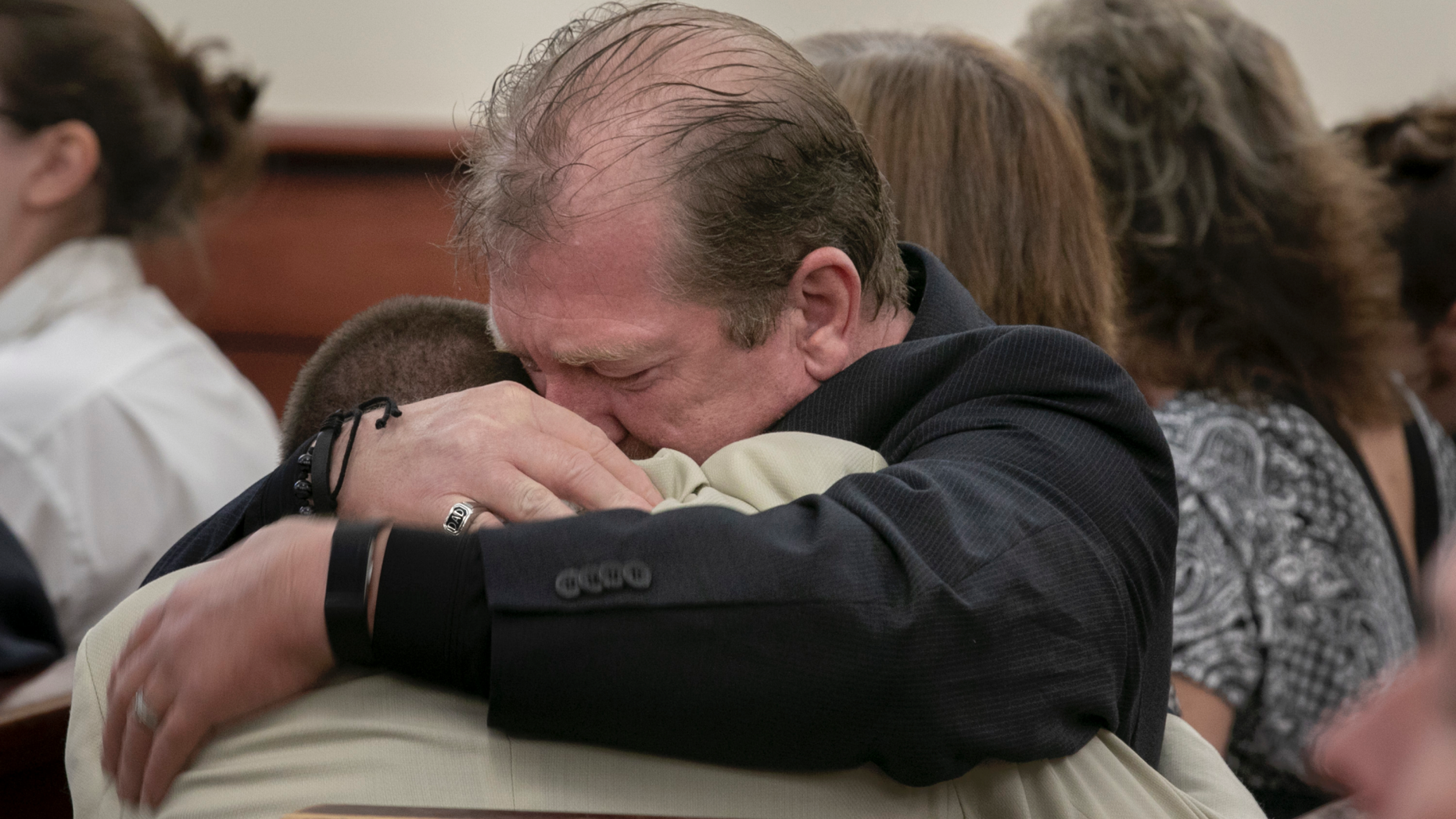 Tim Jones, Sr., embraces his son, Travis Jones during the sentencing phase of Tim Jones Jr.'s trial in Lexington, S.C., Wednesday, June 12, 2019. Timothy Jones, Jr. was found guilty of killing his 5 young children in 2014. (Tracy Glantz/The State via AP, Pool)