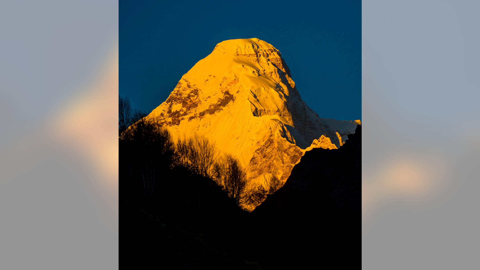 In this Oct. 8, 2016, photograph provided by Juniper Outdoor Pursuits Centre Pvt. Ltd., shows early morning light falling on Nanda Devi east base peak, seen from Pachu valley in Uttarakhand, India. Indian air force pilots have resumed a search over a Himalayan mountain for a team of mostly foreign climbers missing since late May. The fourth day of the search on Tuesday was taking place in the northern state of Uttarakhand after five bodies were spotted in the snow in high-resolution photos taken Monday. (Maninder Kohli/Juniper Outdoor Pursuits Centre Pvt. Ltd. via AP)