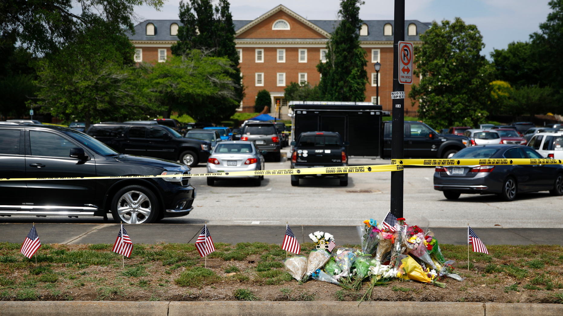 FILE - In this June 1, 2019, file photo, a makeshift memorial rests at the edge of a police cordon in front of a municipal building that was the scene of a shooting in Virginia Beach, Va. The Virginia Beach killing is one of 11 mass workplace killings dating back to 2006 in the U.S., according to a database of mass killings maintained through a partnership between AP, USA Today and Northeastern University. (AP Photo/Patrick Semansky, File)