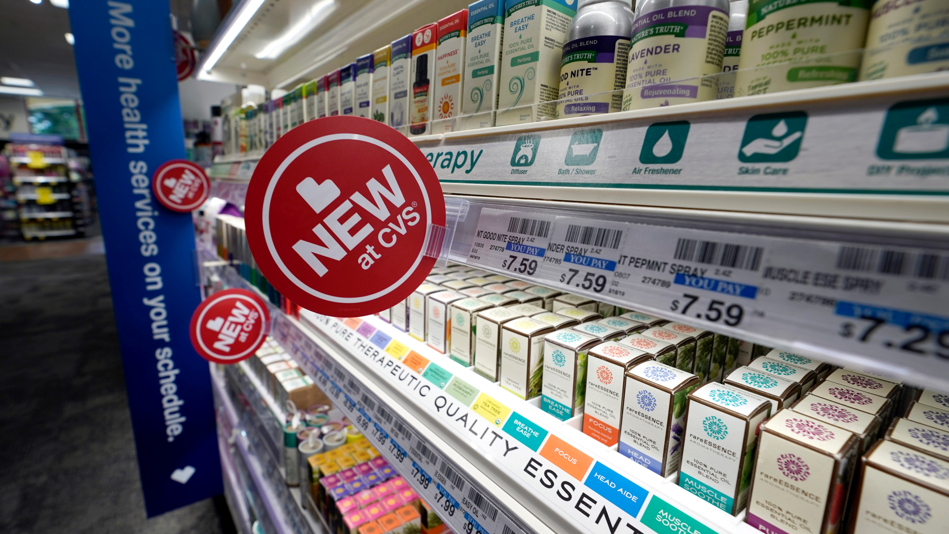 FILE- In this May 30, 2019, file photo, signs advertise new products available inside a CVS store with the new HealthHUB in Spring, Texas. On Wednesday, June 12, the Labor Department reports on U.S. consumer prices for May. (AP Photo/David J. Phillip, File)