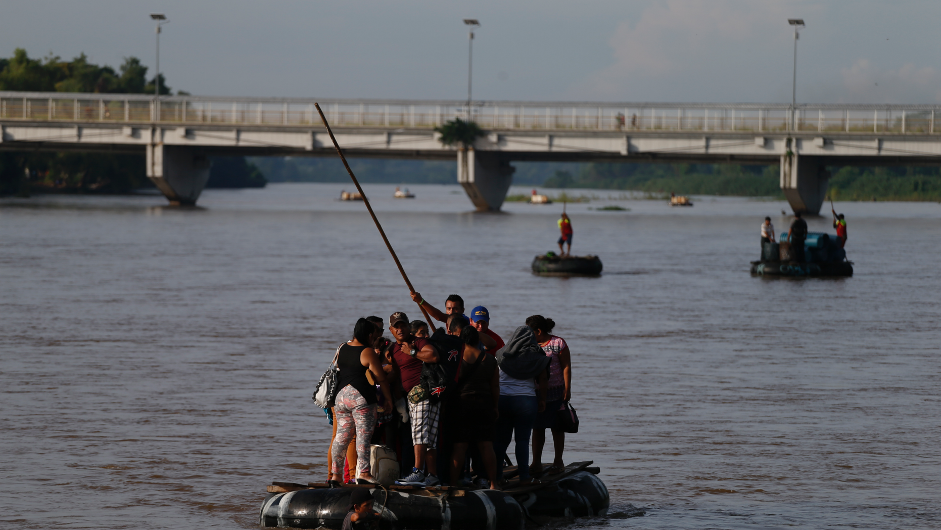 Migrants cross by raft from Tecun Uman, Guatemala, left, to Ciudad Hidalgo, Mexico, on Friday, June 14, 2019. Raftsmen and riverfront business operators said the flow of migrants through the crossing has decreased noticeably since the announcement a few days ago that Mexico's new National Guard would be deploying to the border. (AP Photo/Rebecca Blackwell)