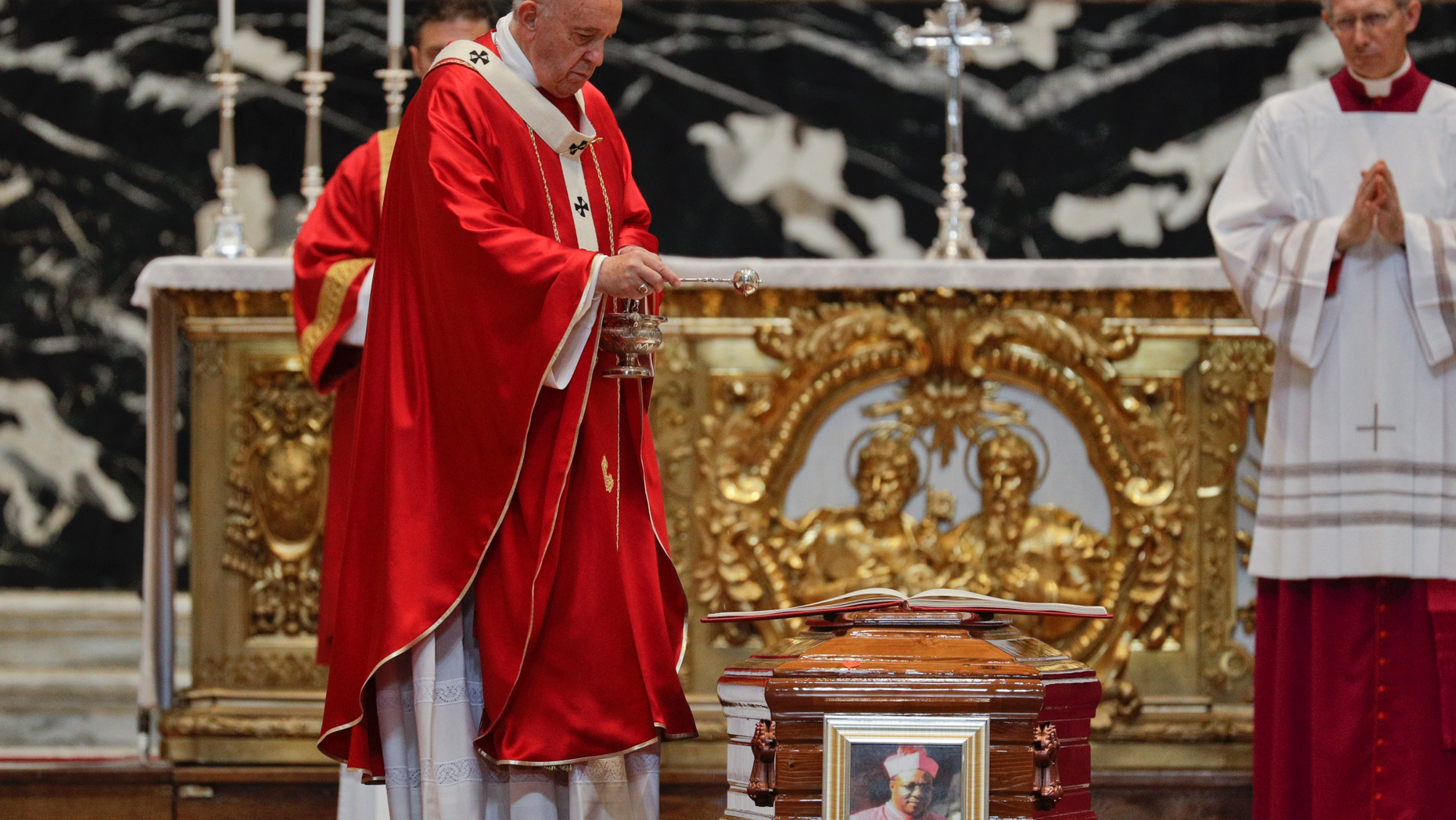 Pope Francis blesses the coffin as he celebrates the funeral service of Cardinal Leon Kalenga Badikebele, the Apostolic nuncio in Argentina, in St. Peter's Basilica at the Vatican, Saturday, June 15, 2019. (AP Photo/Gregorio Borgia)