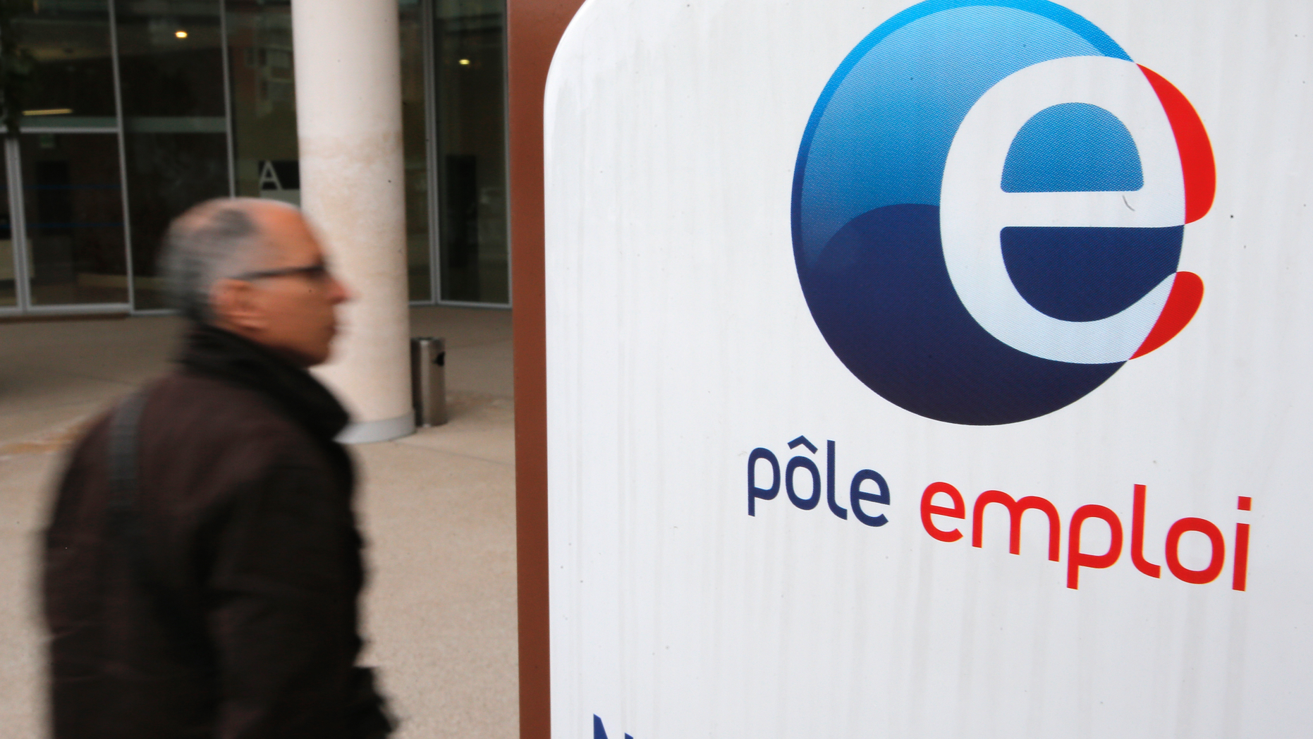FILE - In this Feb.26, 2013 photo, a job seeker enters a job center (Pole Emploi), in Nice, southeastern France. French President Emmanuel Macron's government has unveiled its plan to tighten the country's unemployment benefits. All major workers unions denounce the reform as unfair and damaging to the country's social system. (AP Photo/Lionel Cironneau, File)