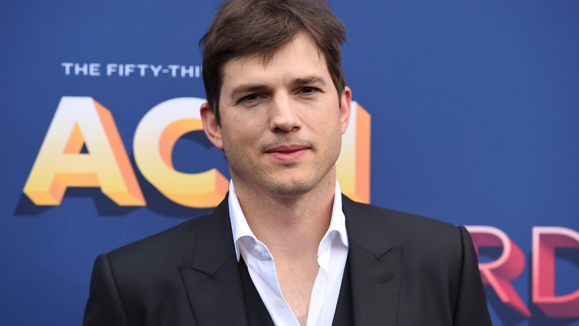 FILE - In this April 15, 2018, file photo, Ashton Kutcher arrives at the 53rd annual Academy of Country Music Awards at the MGM Grand Garden Arena in Las Vegas. The News and Sentinel reports Parkersburg High School Principal Kenny DeMoss was suspended Tuesday, June 11, 2019 at a Wood County Board of Education meeting. DeMoss apologized for heavily basing his May address on Kutcher's 2013 Nickelodeon Teen Choice Awards speech. He has said he should’ve cited his sources, but the ideas were his own. (Photo by Jordan Strauss/Invision/AP, File)