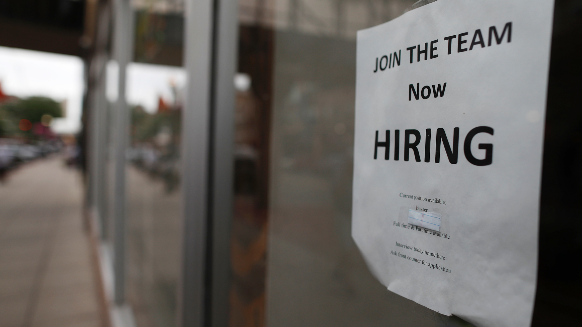 FILE - In this July 18, 2018, file photo a "now hiring" sign hangs in the window of a Chinese restaurant in downtown Fargo, N.D. A U.S. Chamber of Commerce-MetLife survey released last week found that 28% of small businesses plan to increase their staffs in the next year, down slightly from 29% in the first quarter. (AP Photo/David Zalubowski, File)