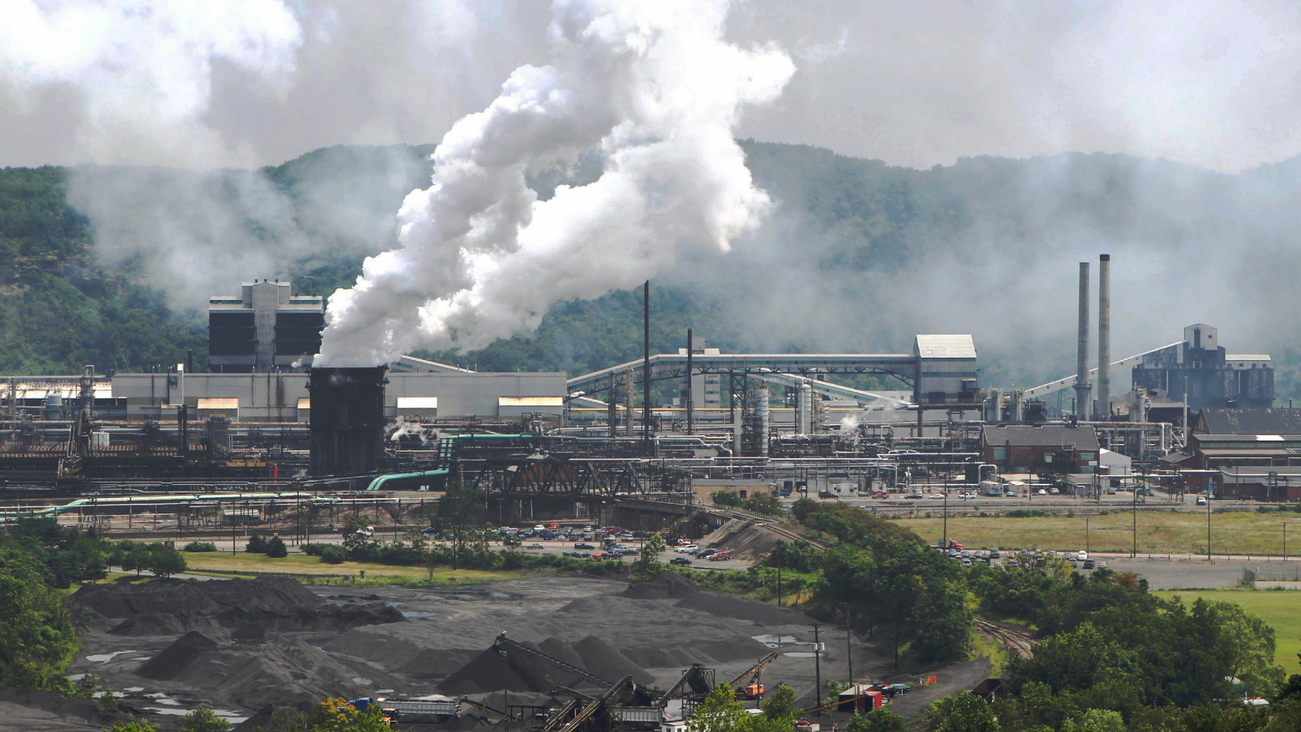 FILE- This July 14, 2010 archive photo shows smoke that escapes Clairton Coke Works from the United States Steel Corp. in Clairton, Pennsylvania. A fire in the huge US Steel Coke Plant in Pittsburgh put out of action a key pollution control system on Monday, June 17, 2019. This triggered a health alert as authorities monitored the air around from the plant looking for signs of toxic sulfur dioxide release. This was the second fire since December in the coke plant, the largest facility of its kind in the United States. The plant turns coal into coke, one of the raw materials of steel. (AP Photo / Keith Srakocic, File)