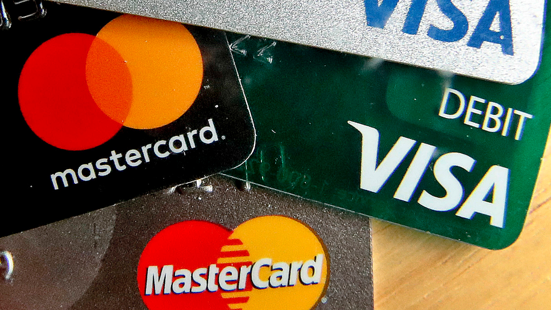 FILE - In this Feb. 20, 2019, file logos for credit cards are visible on the cards in Zelienople, Pa. On Friday, June 7, the Federal Reserve releases its April report on consumer borrowing. (AP Photo/Keith Srakocic, File)