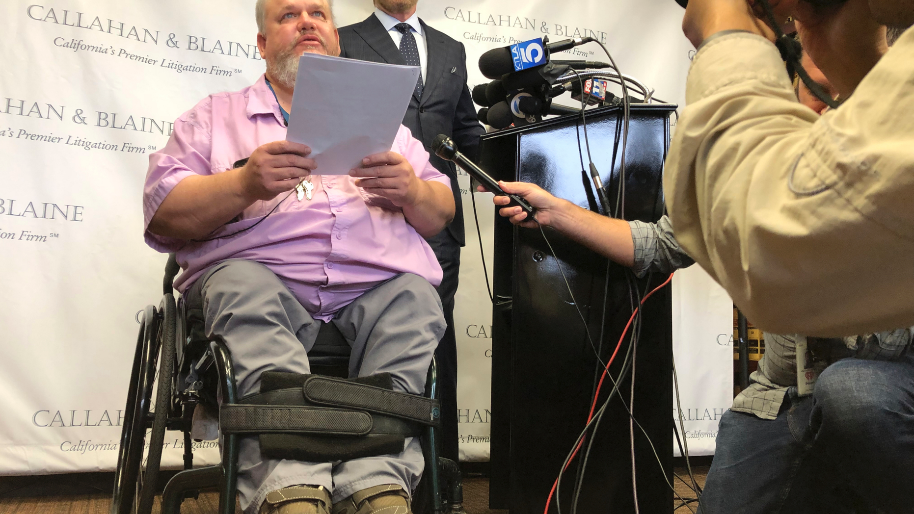 Attorney Daniel J. Callahan, right, looks at his client, Geoffrey Johnson, during a news conference announcing a lawsuit filed against lawyer Michael Avenatti in Santa Ana, Calif., Thursday, June 13, 2019. Johnson says that Avenatti, his former lawyer, received a $4 million settlement check from Los Angeles County over injuries he suffered in sheriff department custody and failed to pay Johnson his share or tell him the check was in. (AP Photo/Amy Taxin)